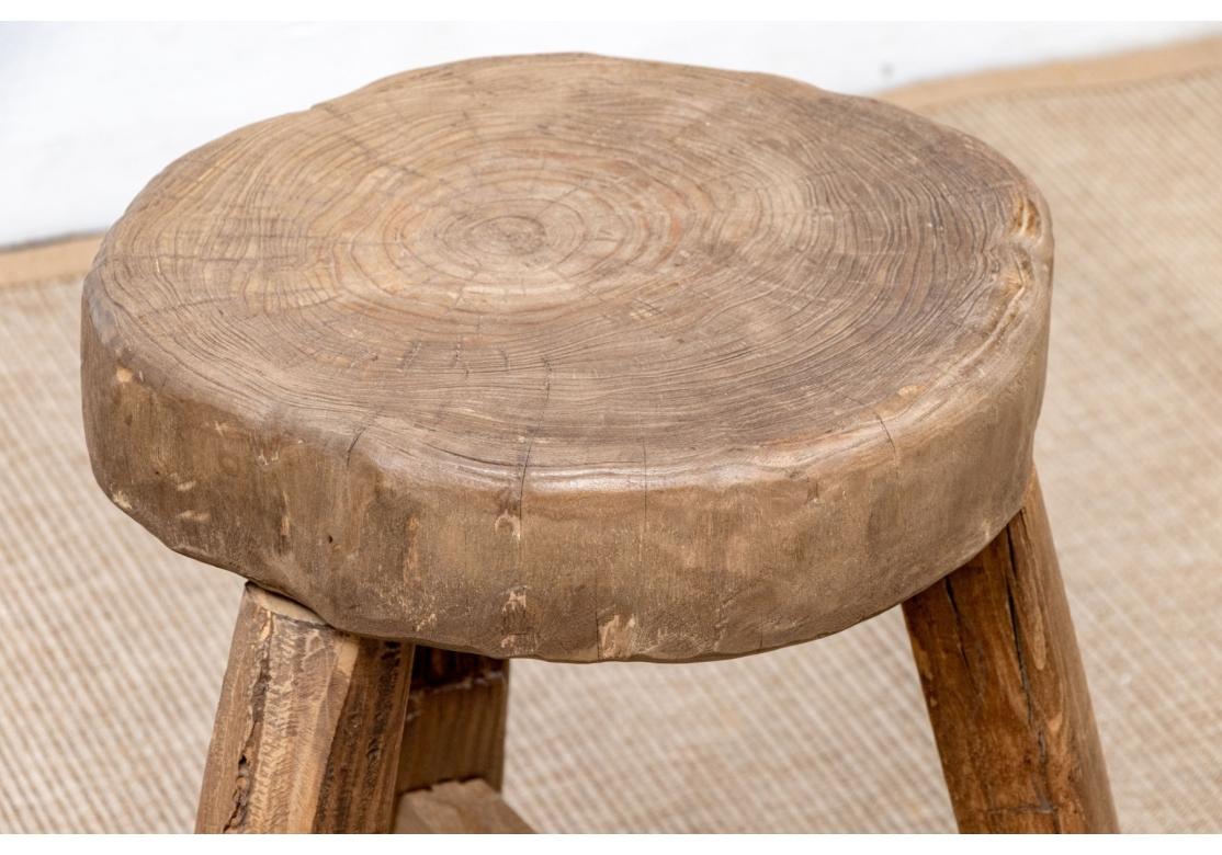 A very well crafted Stool with peg construction which has a fine seat made from a single slab cut from a tree clearly showing the age rings to great effect. Time softened and well finished with a soft hand and great solidity. The Stool may be used