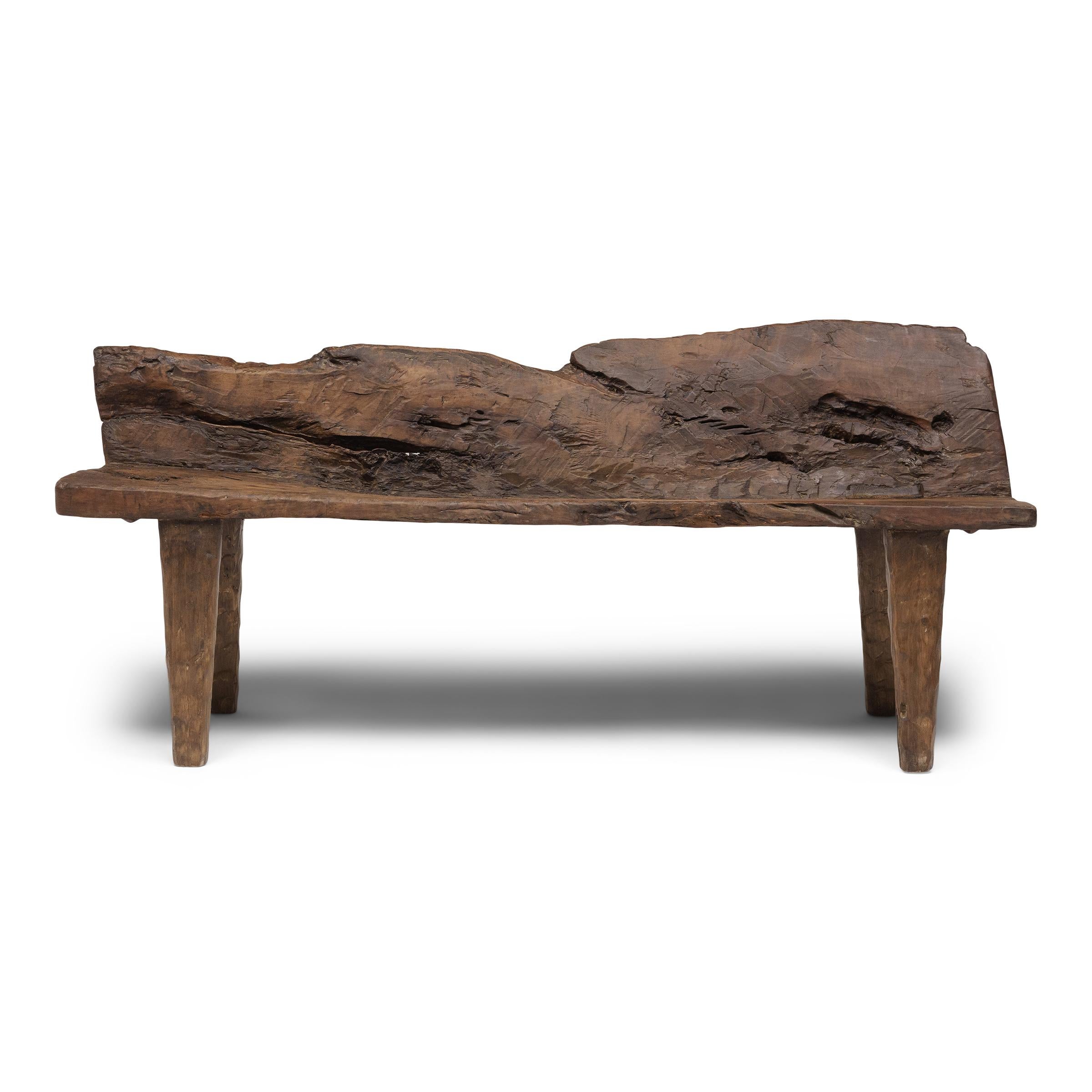 With freeform shape and incredible texture, this low courtyard bench from Shandong province embodies the spirit of wabi-sabi, the Japanese philosophy that beauty and integrity can be found within the imperfections of a timeworn object. The plank top
