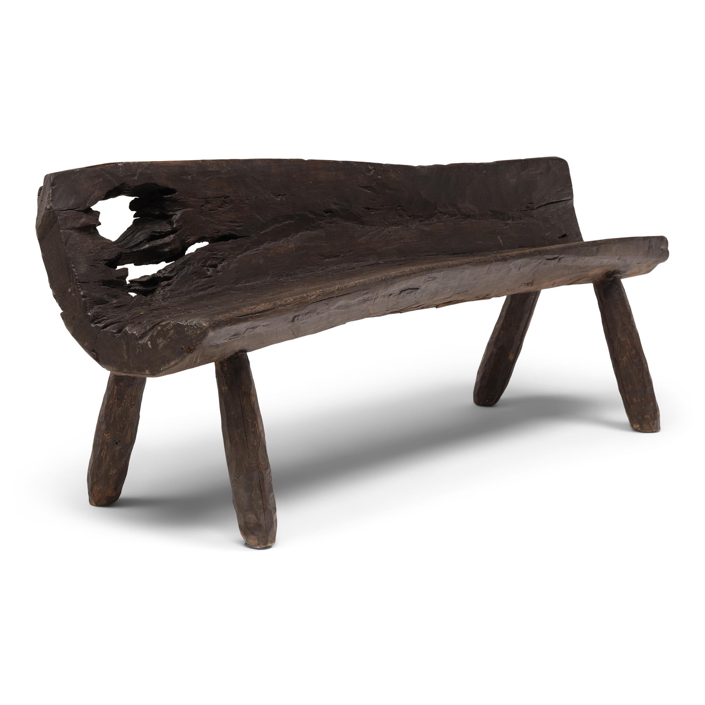 With freeform shape and incredible texture, this low courtyard bench from Shandong province embodies the spirit of wabi-sabi, the Japanese philosophy that beauty and integrity can be found within the imperfections of a timeworn object. The curved