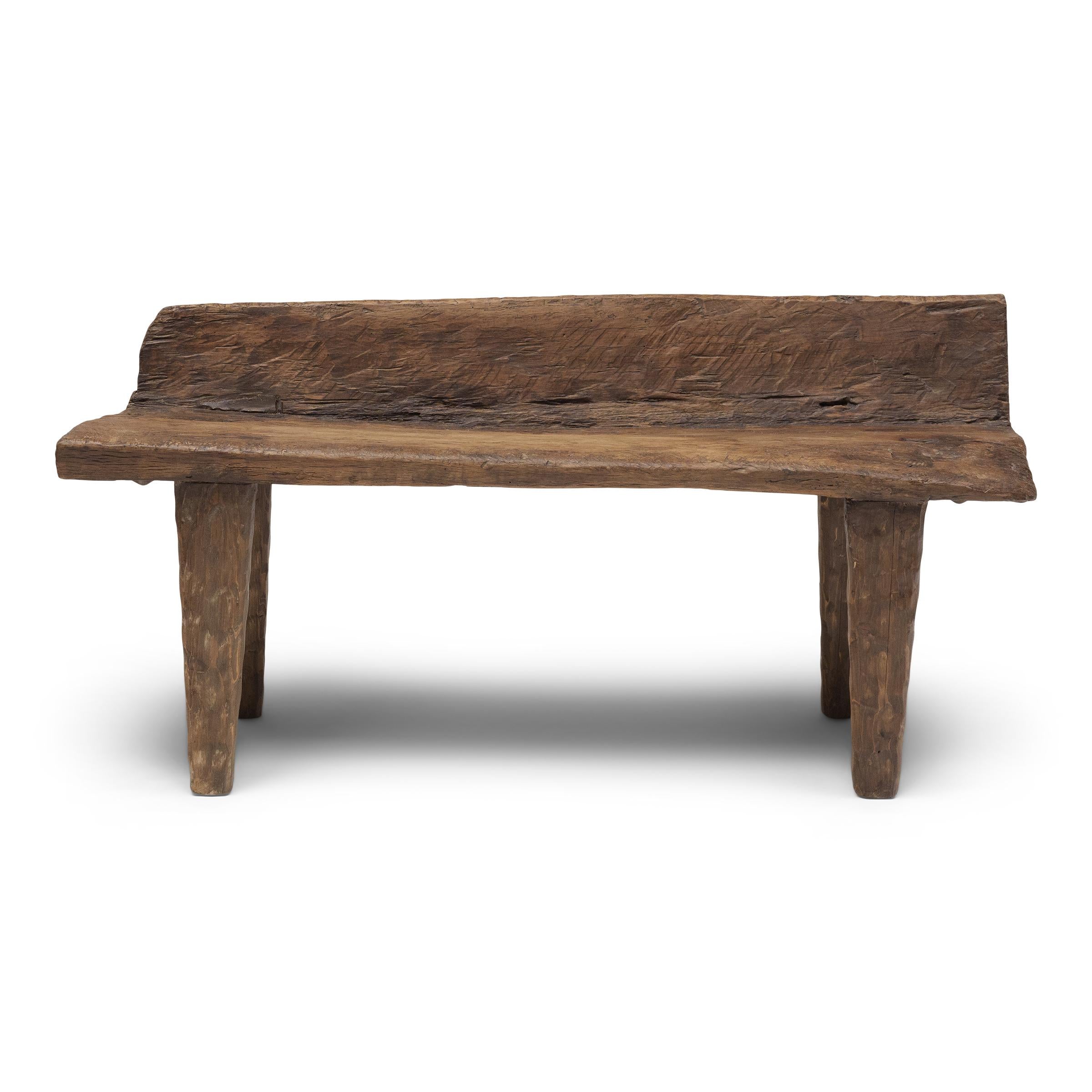 With freeform shape and incredible texture, this low courtyard bench from Shandong province embodies the spirit of wabi-sabi, the Japanese philosophy that beauty and integrity can be found within the imperfections of a timeworn object. The plank top