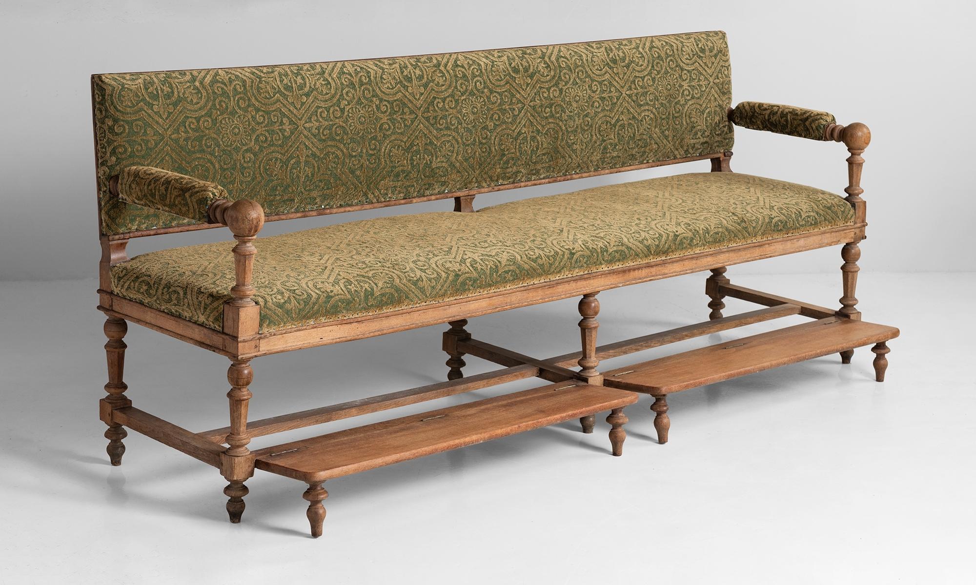 Primitive Hotel Bench, France, circa 1920.

Carved oak frame, reupholstered in antique fabric, with exposed back.