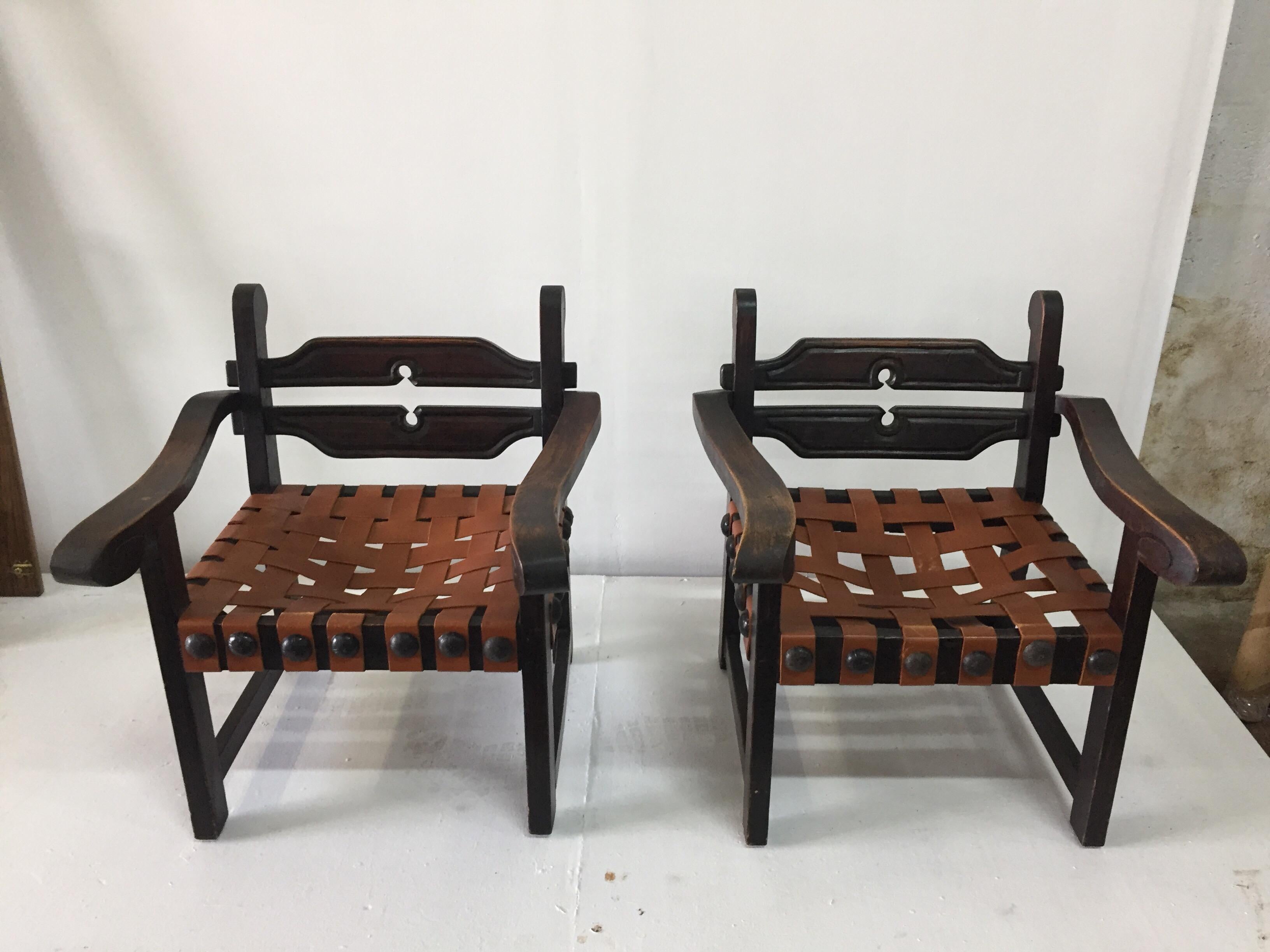 This is a wonderful authentic pair of chairs by the artist and silversmith designer William Spratling, made in his workshop in Taxco in the 40s.  Sabino wood and genuine leather seats, rustic and original hammered metal oversized nail head trim