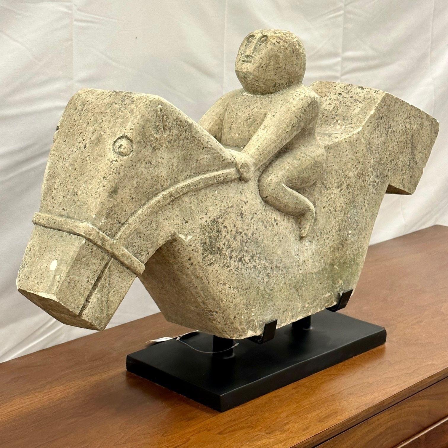 Primitive Mid-Century Modern Indonesian stone sculpture, statue on stand, 20th C
Primitively hewn sculpture of a rider on an apparently briskly galloping horse. Overall shape brings to mind the motion of rolling waves and suggests a correlation