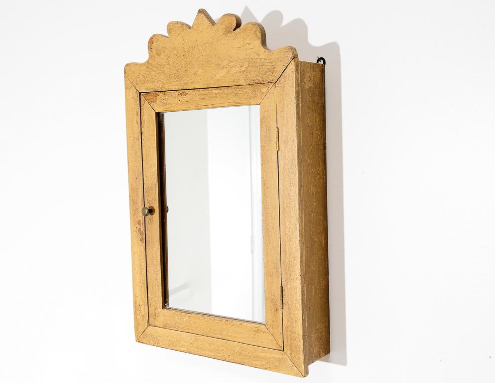 Mirror medicine cabinet in an early American style.