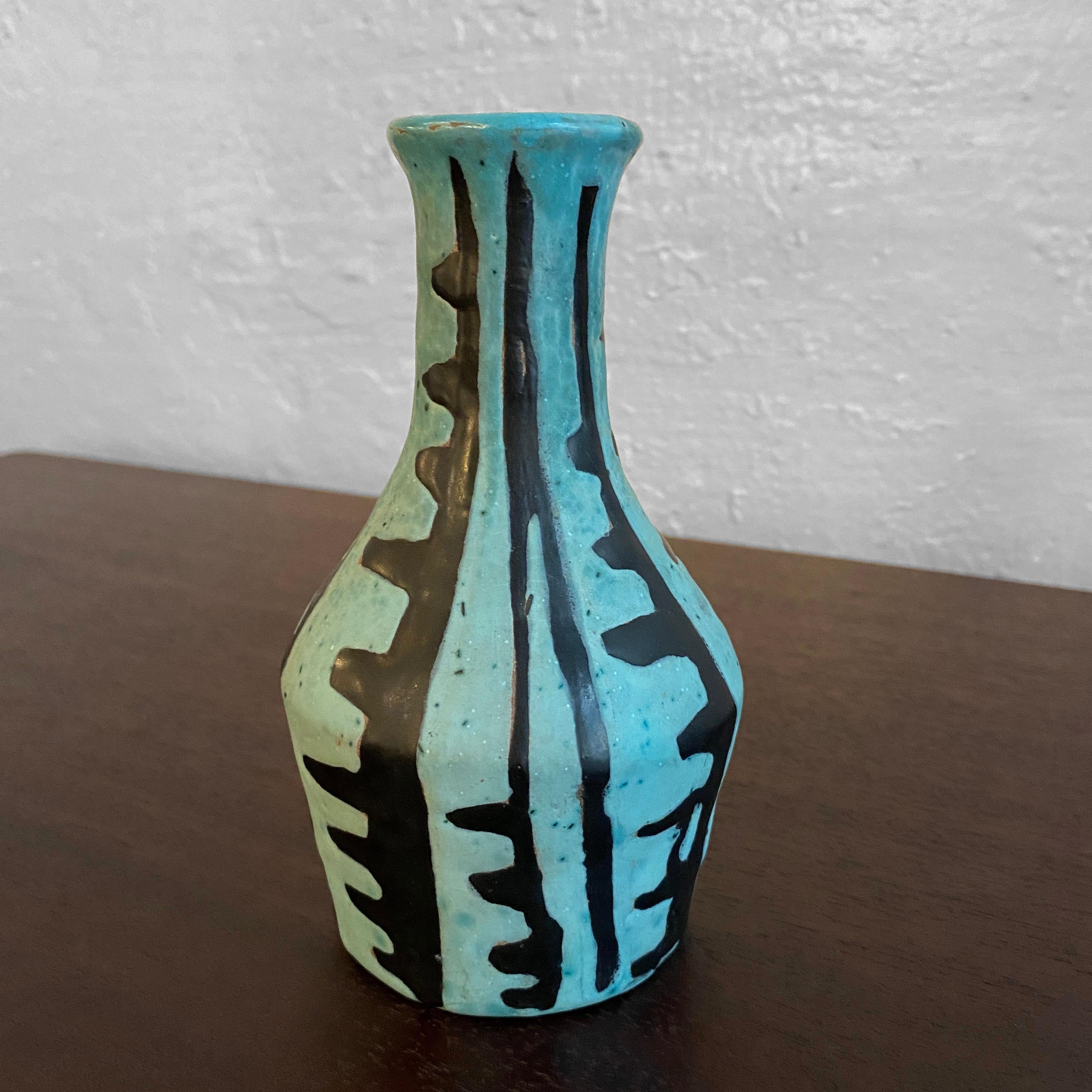 Small, Mid-Century Modern, art pottery vase by Hungarian artist Livia Gorka features a hand-painted, tribal motif in black and blue. The mouth opening measures 1 inch.