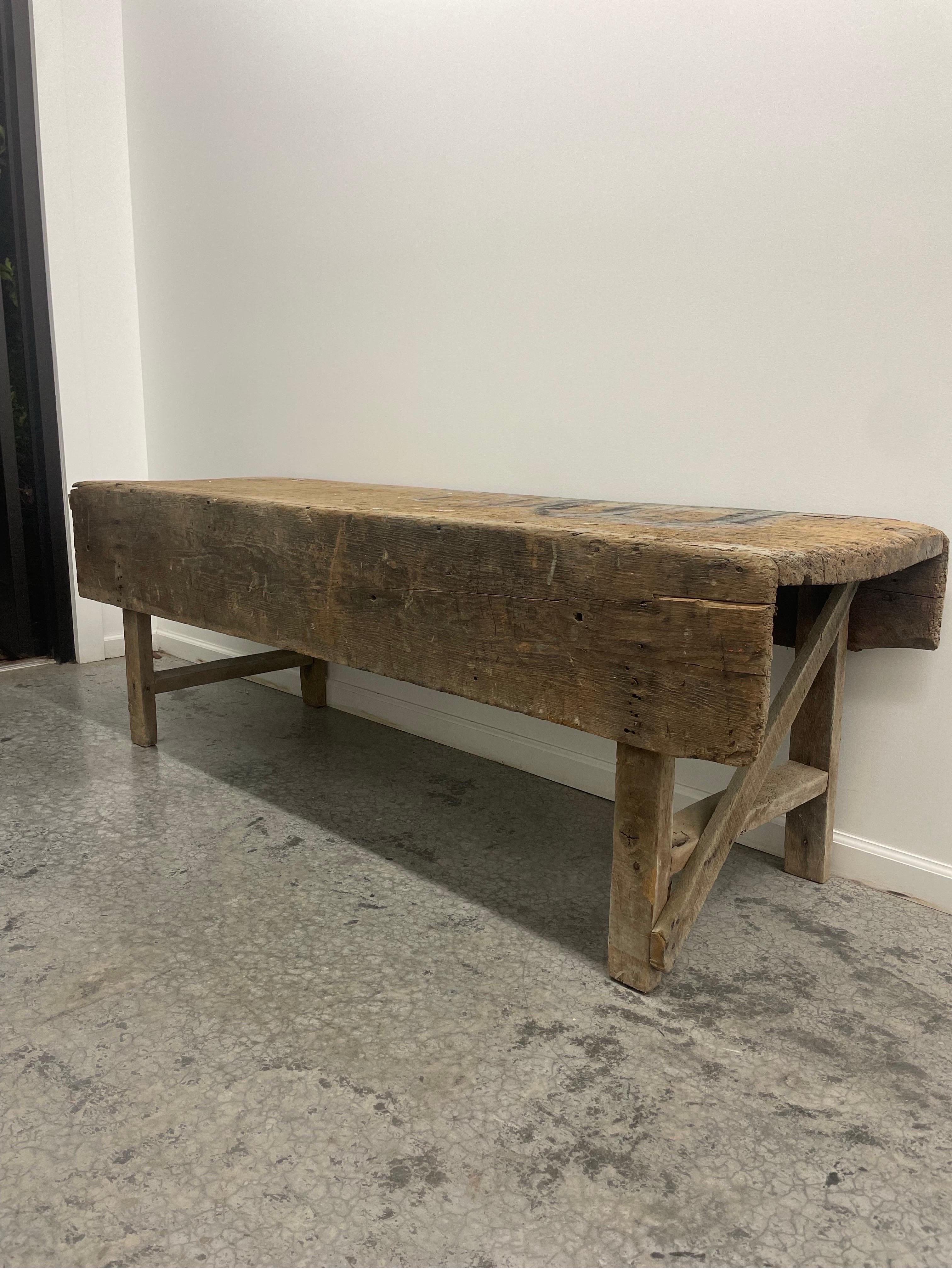 Large Brutalist carpenters bench or work table with patina due to age in all the right places. Past History as Mortuary Table Circa 1800's.

This is quite simply one of the most interesting pieces I have ever had in. 

This came a private