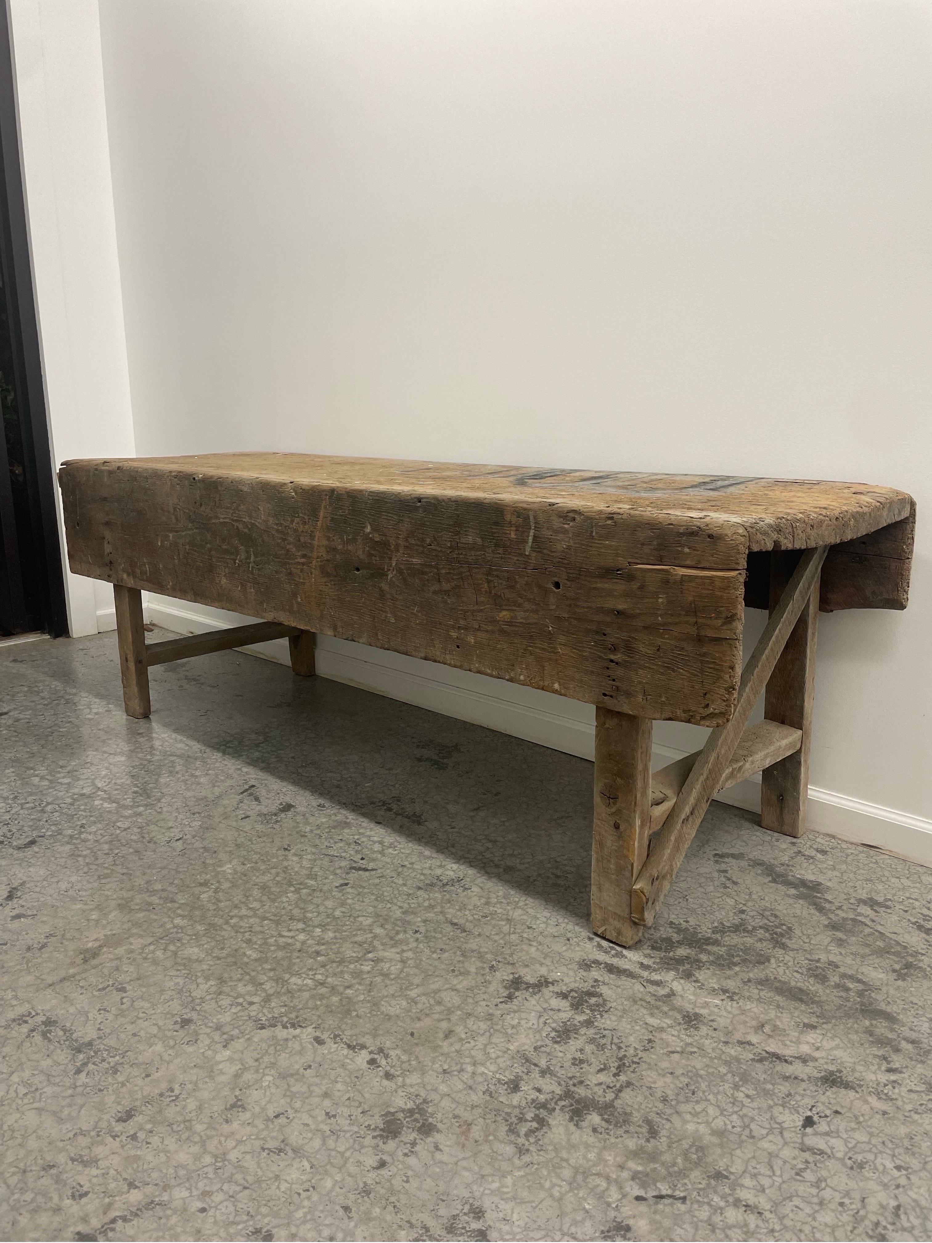 Large Brutalist carpenters bench or work table with patina due to age in all the right places. Past History as Mortuary Table Circa 1800's.

This is quite simply one of the most interesting pieces I have ever had in. 

This came a private