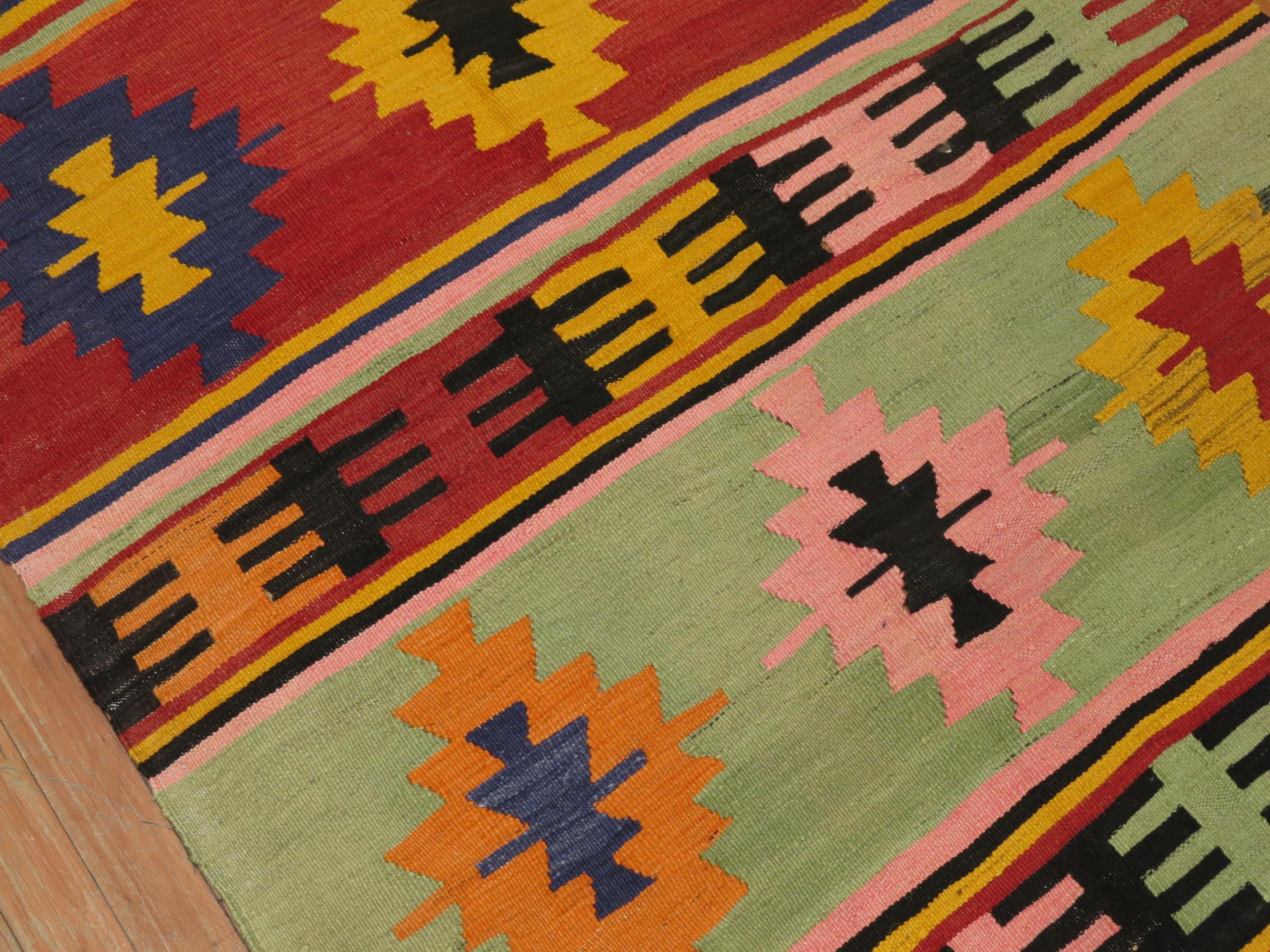 Turkish Kilim from the mid-20th century with an array of bright colors.

Measures: 3'4