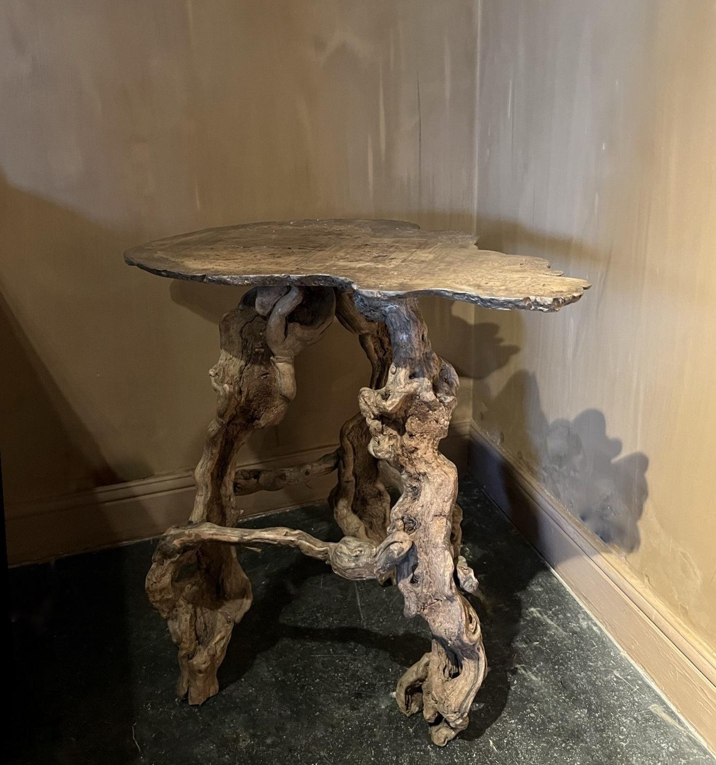 A organic sidetable made from reclaimed winebranches and a lovely piece of burlwood. Probably early 20th century.
