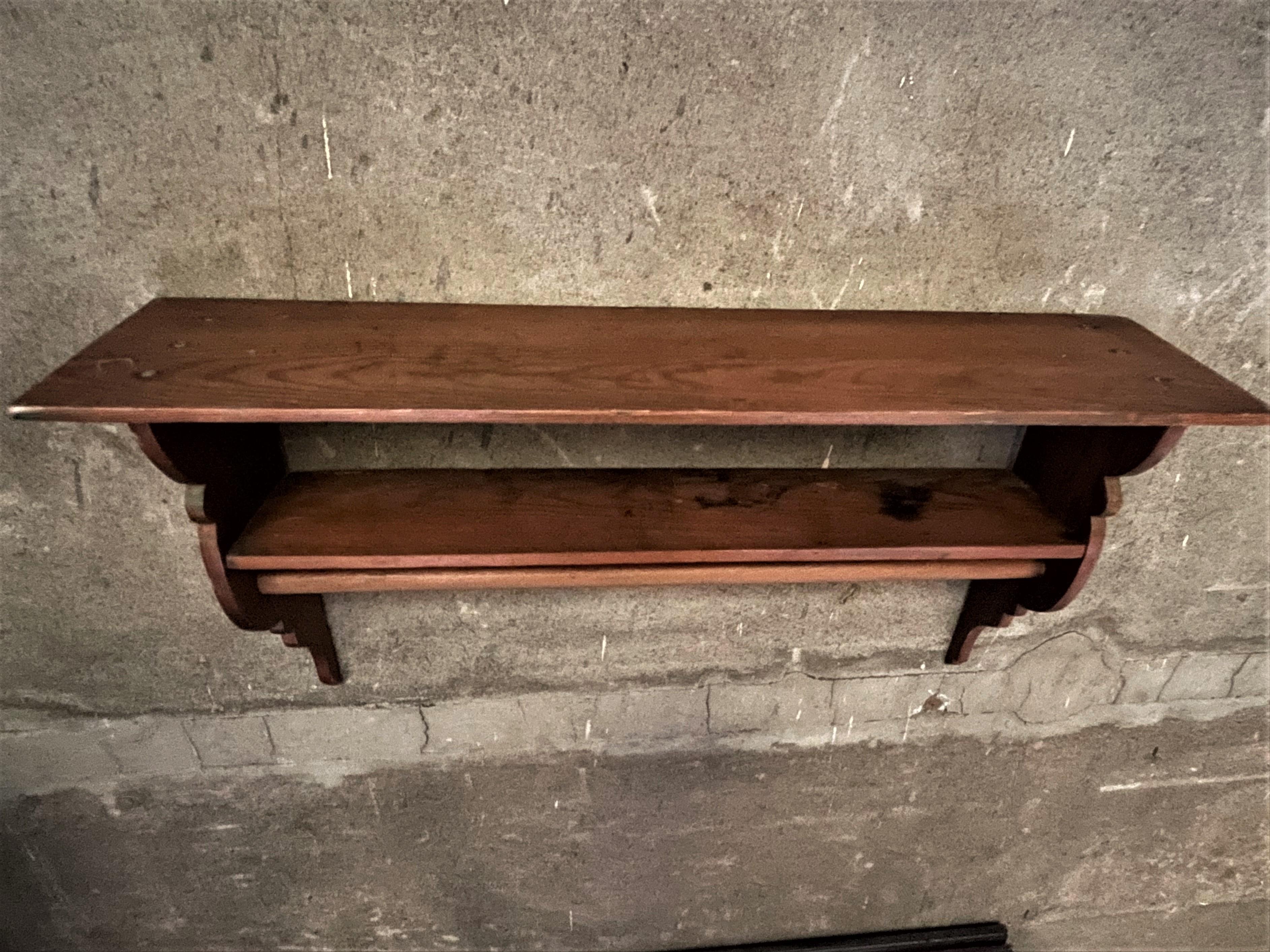 What an adorable two tier shelf with a coat rod below and sweet shaped ends, made of lovely grained pine. It is a very usable small size, the top shelf being 28 3/4 inches wide, the entire piece is 14 3/4 inches high and 6 3/4 inches deep, the width