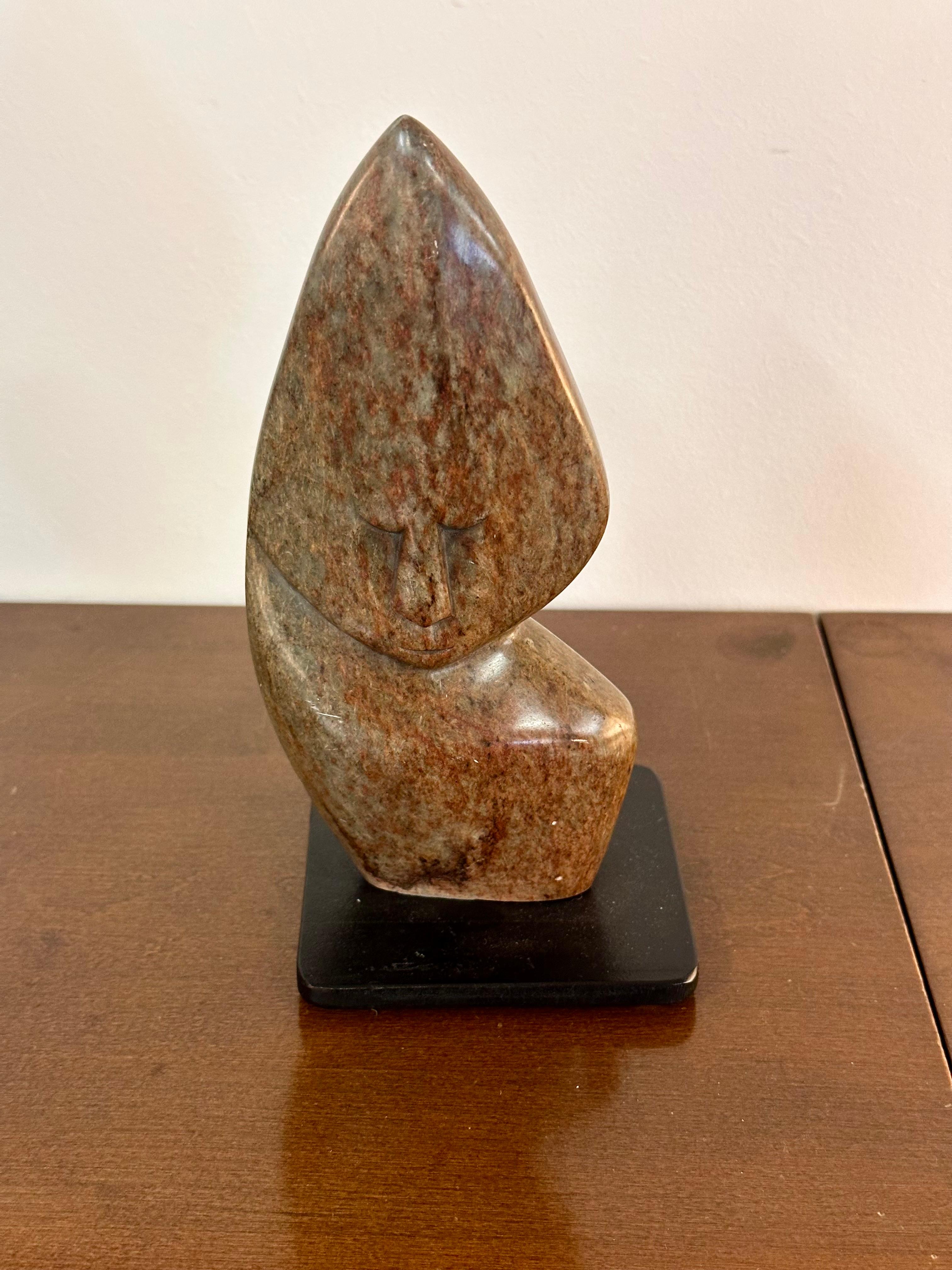 Primitive Polished Marble Stone Sculpture

This striking sculpture is a primitive piece of unknown age and origin, but likely from Africa. It has been hand-carved of polished marble and mounted on a metal base. The dominant colors in the stone are
