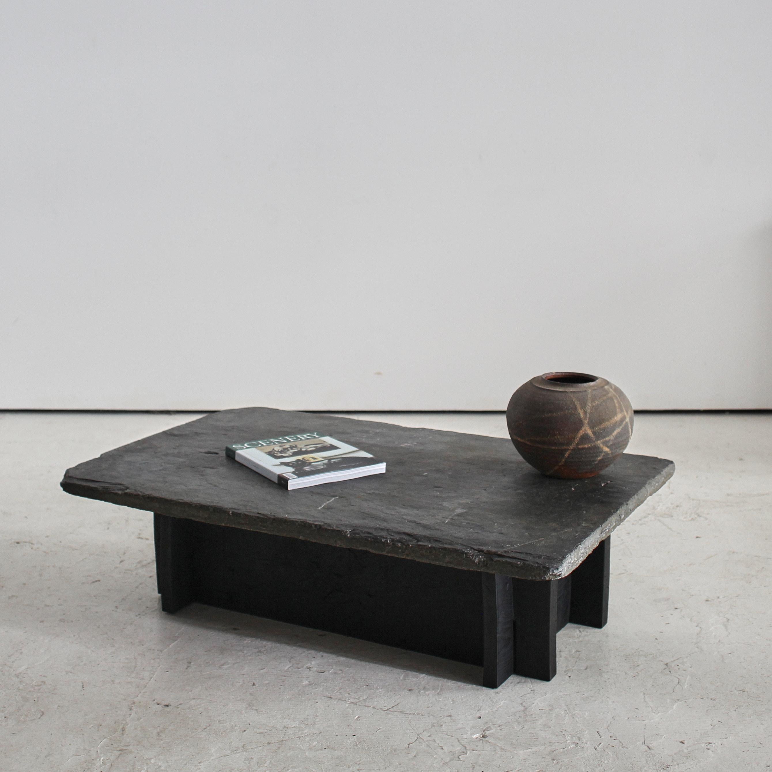 A northern Portuguese slate & chestnut coffee table.

Constructed using a thick 19th C. riveren slate slab on 18th C. Charred chestnut base.

A one off made in our London workshop.