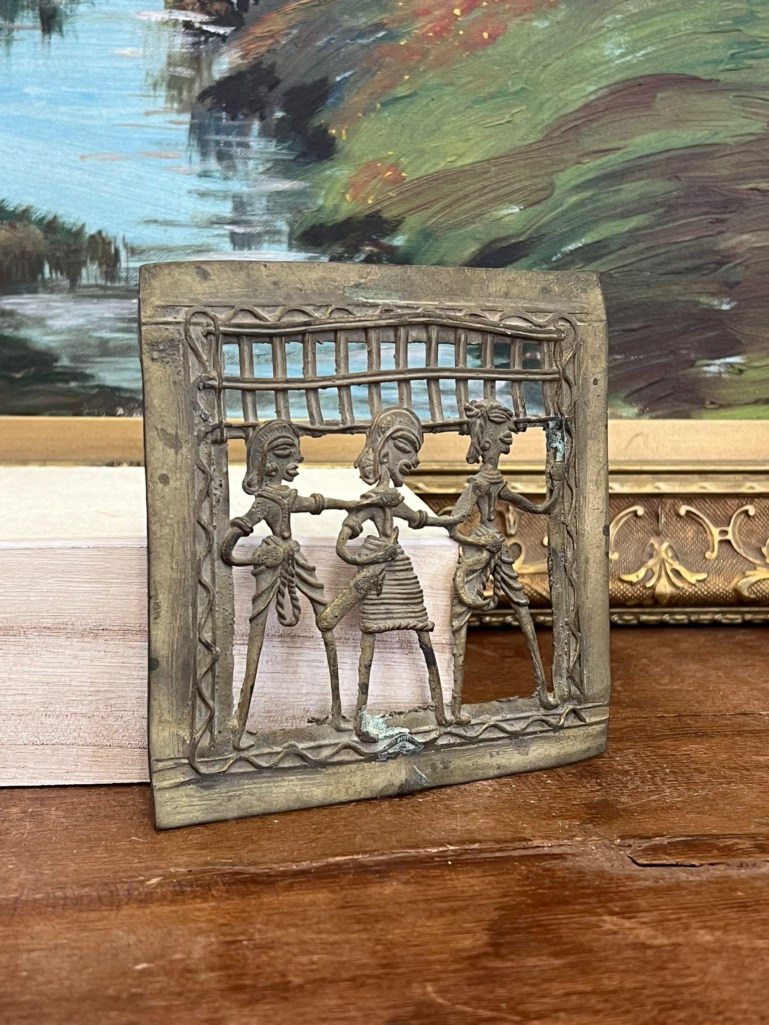 This Piece of primitive decorative wall art depicts a tribal dancing scene and is possibly brass I’m material. This Piece has nice patina and character. Vintage Condition as pictured. Listing is for described item only. (Box H14)

Dimensions. 4.75”W