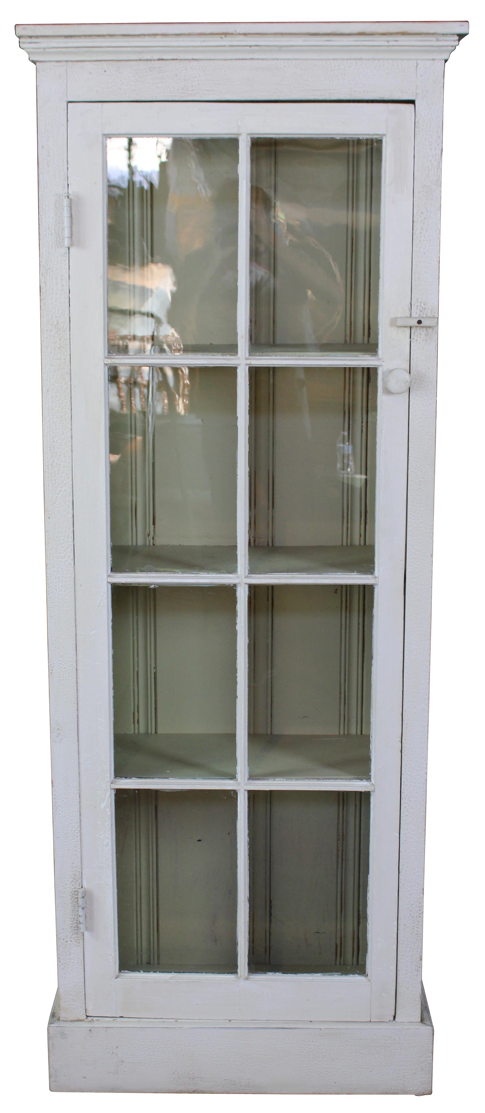 Primitive reclaimed pine country farmhouse cupboard, linen press or cabinet. Features a chic white distressed painted finish and paneled glass doors.
  