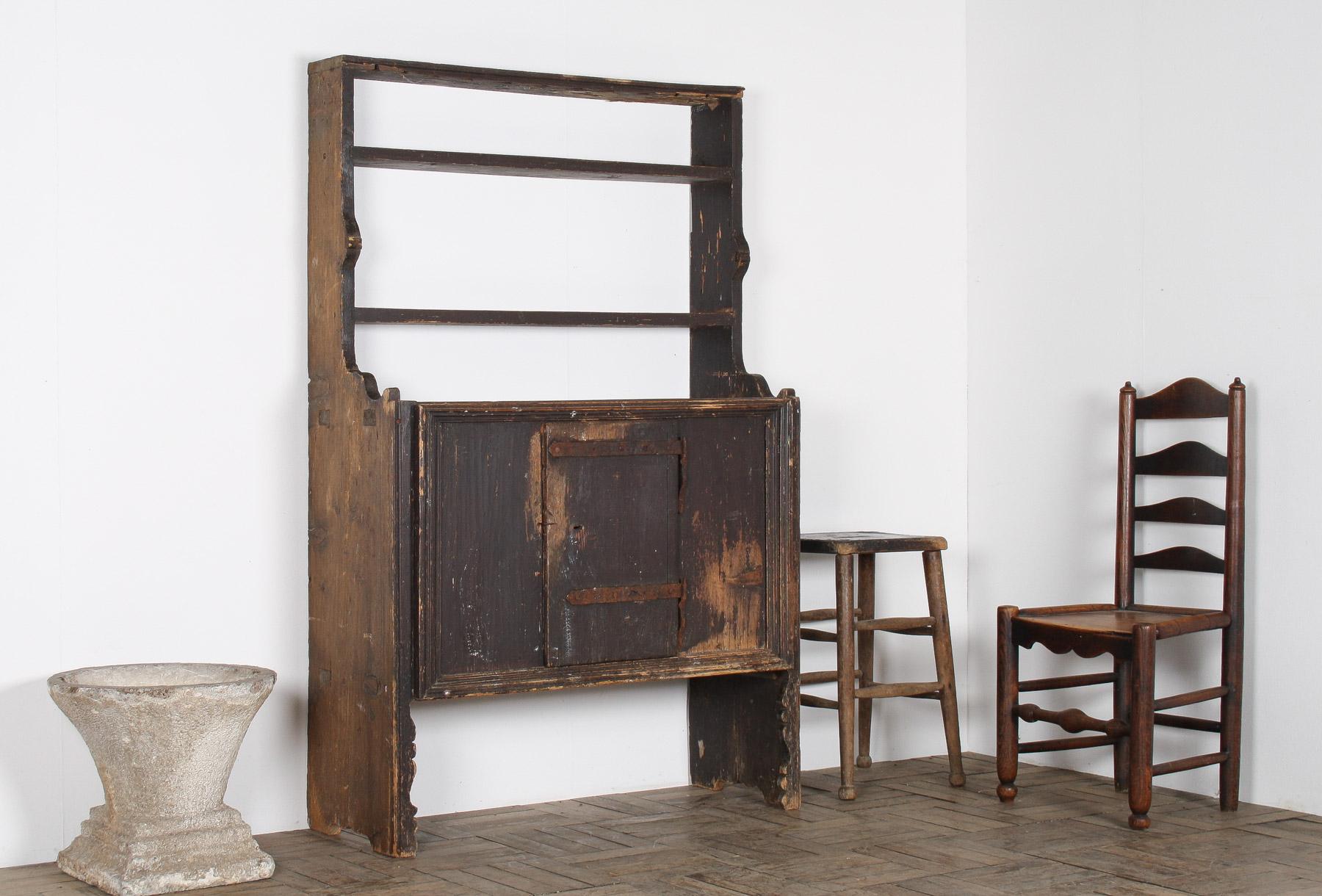 A beautiful unique rustic dresser unit, originates from a Hungarian village farmhouse.  A very old piece, likely mid 19th century, and although primitive in construction it is very well built and made to last.

The dresser has open shelves with a
