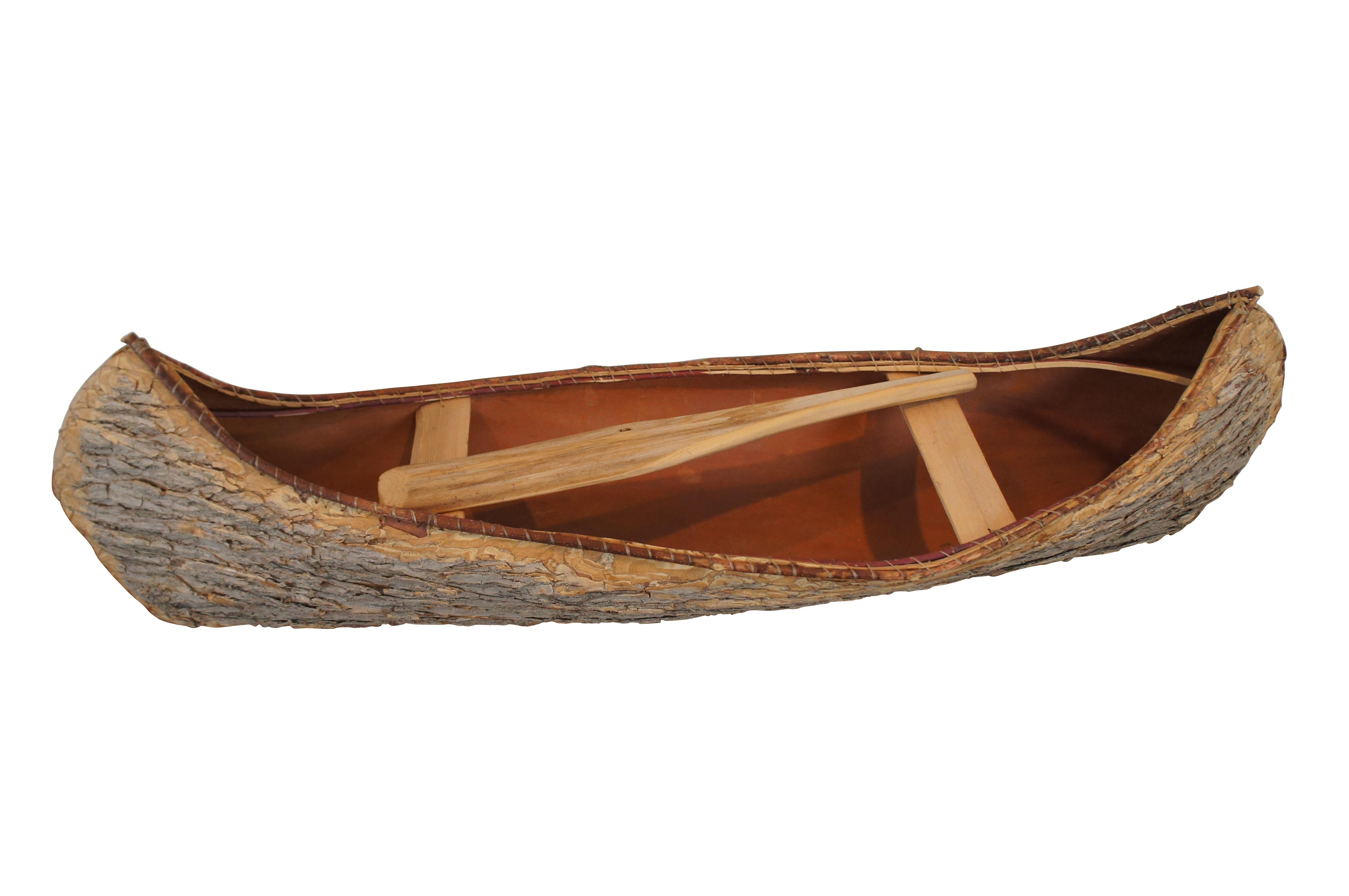 Vintage 1/3 scale folk art canoe model.  Made of birch bark and bentwood featuring traditional primitive construction.  Log cabin, lodge, store display.


DIMENSIONS

47” x 12” x 12.5” (Width x Depth x Height)
