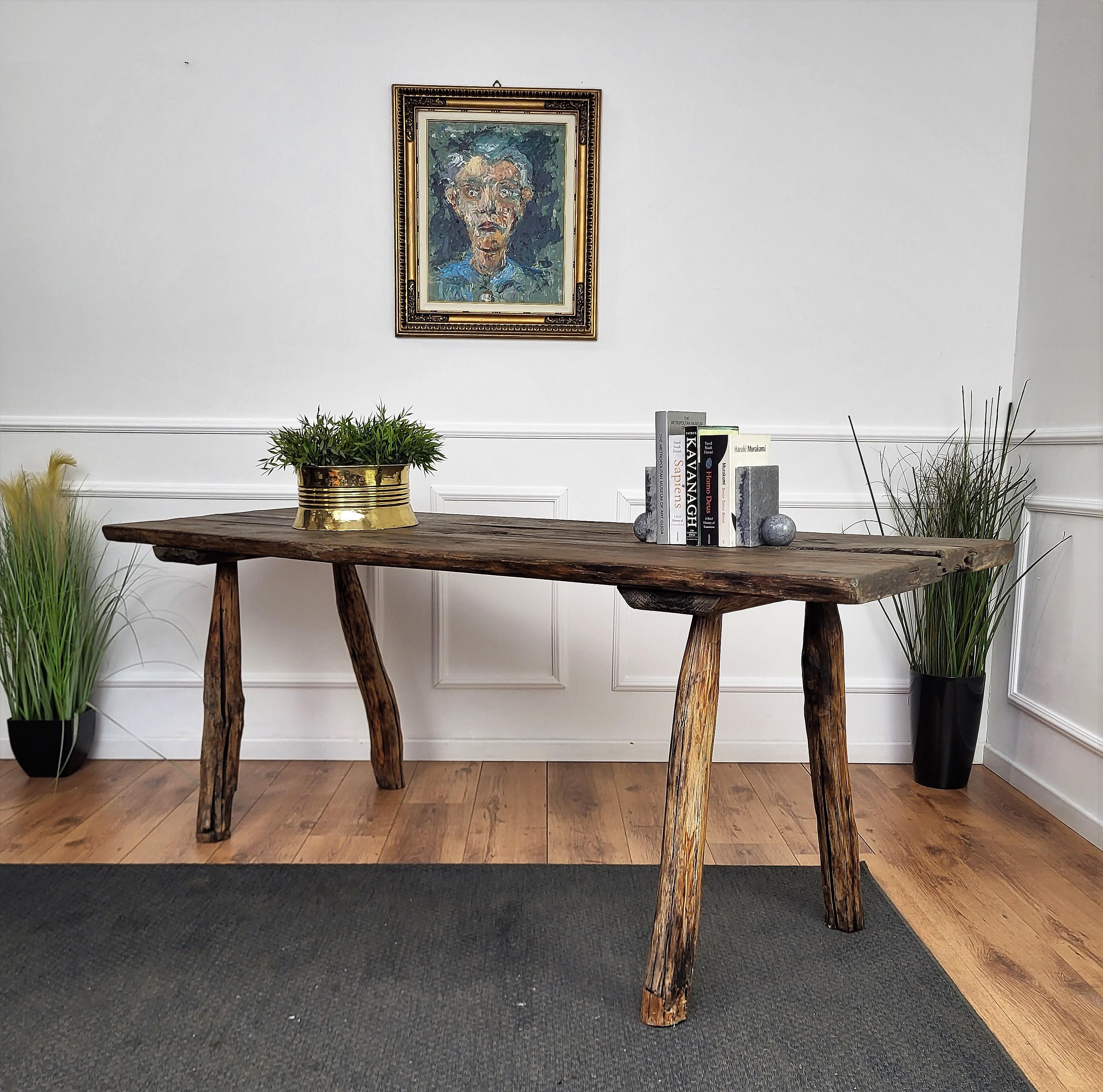 Beautiful Italian rustic primitive country wooden table, with typical legs in original aged natural color giving the rich and beautiful patina that makes it look wonderful in every interior. This piece is in the rustic primitive spirit of organic