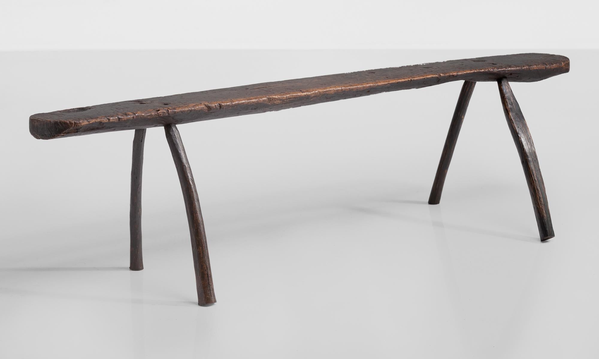 Primitive sculptural bench, England, circa 1790.

Rustic form with curved legs and a seat that measures 8