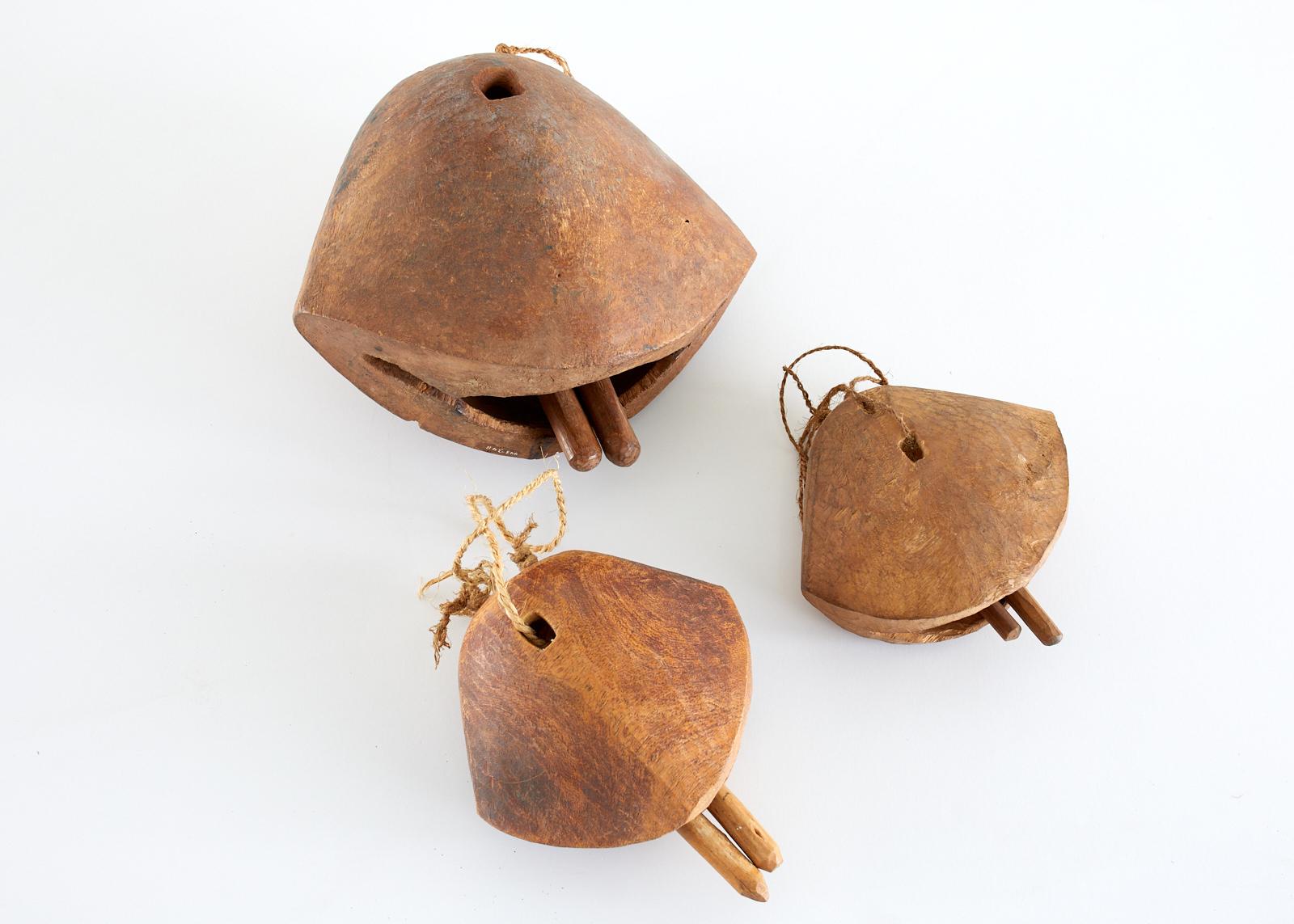 Set of three primitive teak camel bells used by herdsmen in Africa. Camels are held in the highest regard and these were sometimes given as gifts as well as for practical purposes. Set consists of a small, medium, and large bell each including two