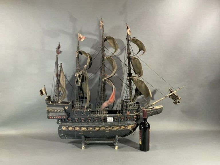 Early 20th century model of a galleon with heavy cloth sails, model has knotted ratlines, deadeyes, badges, etc.

Overall dimensions: 40 x 16 x 45.