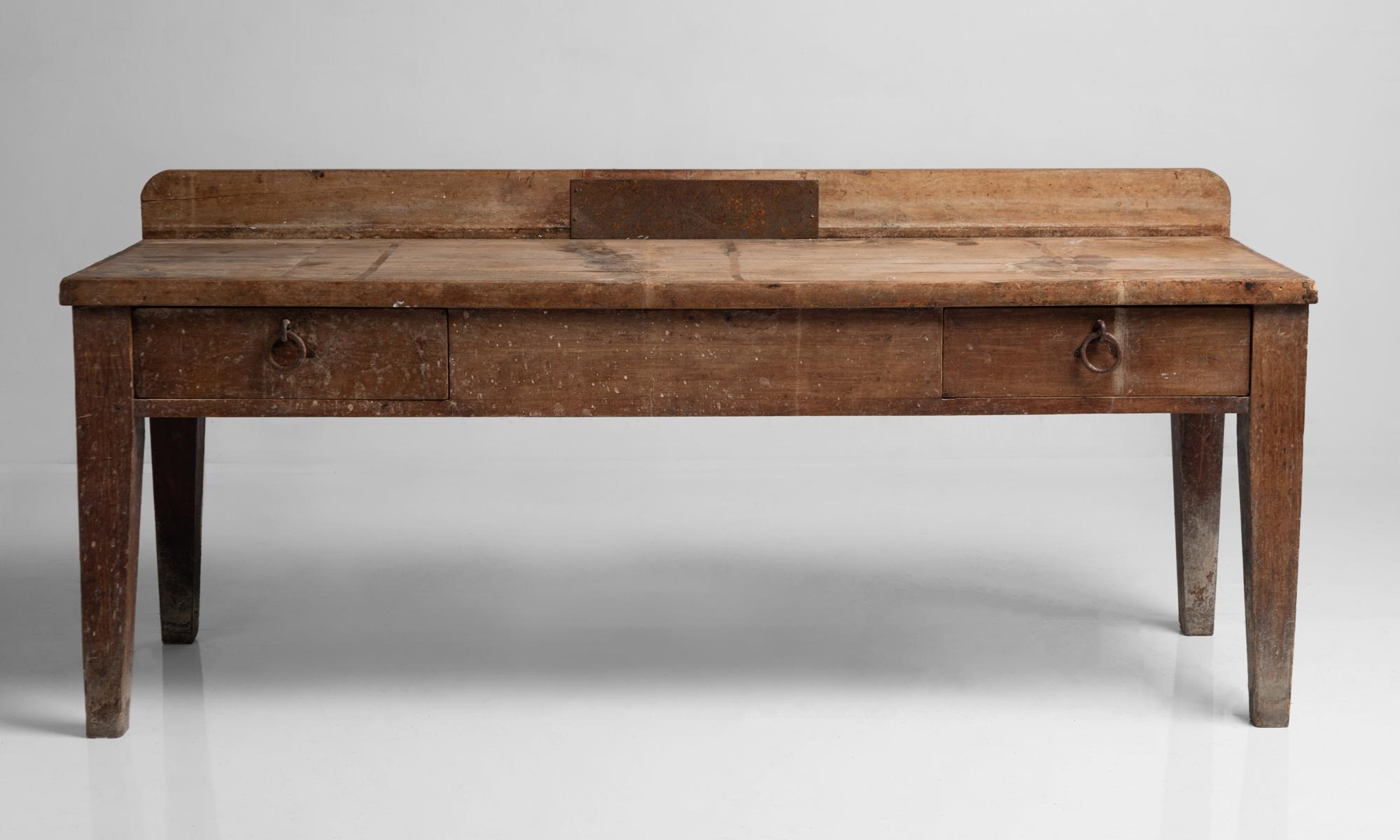 Primitive side board, France, 19th century.

Large rustic work table with oak plank construction and original iron hardware.