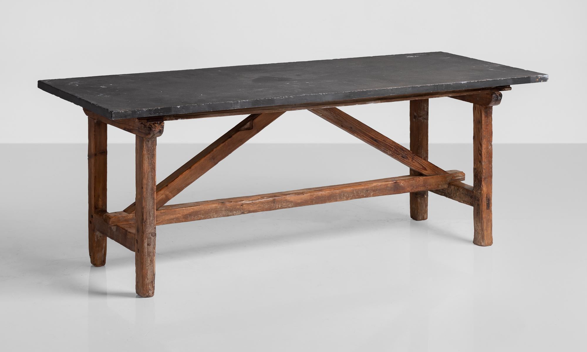 Primitive slate table, France, circa 1930.

Substantial slate top sits on a Primitive pine base with solid construction.
 