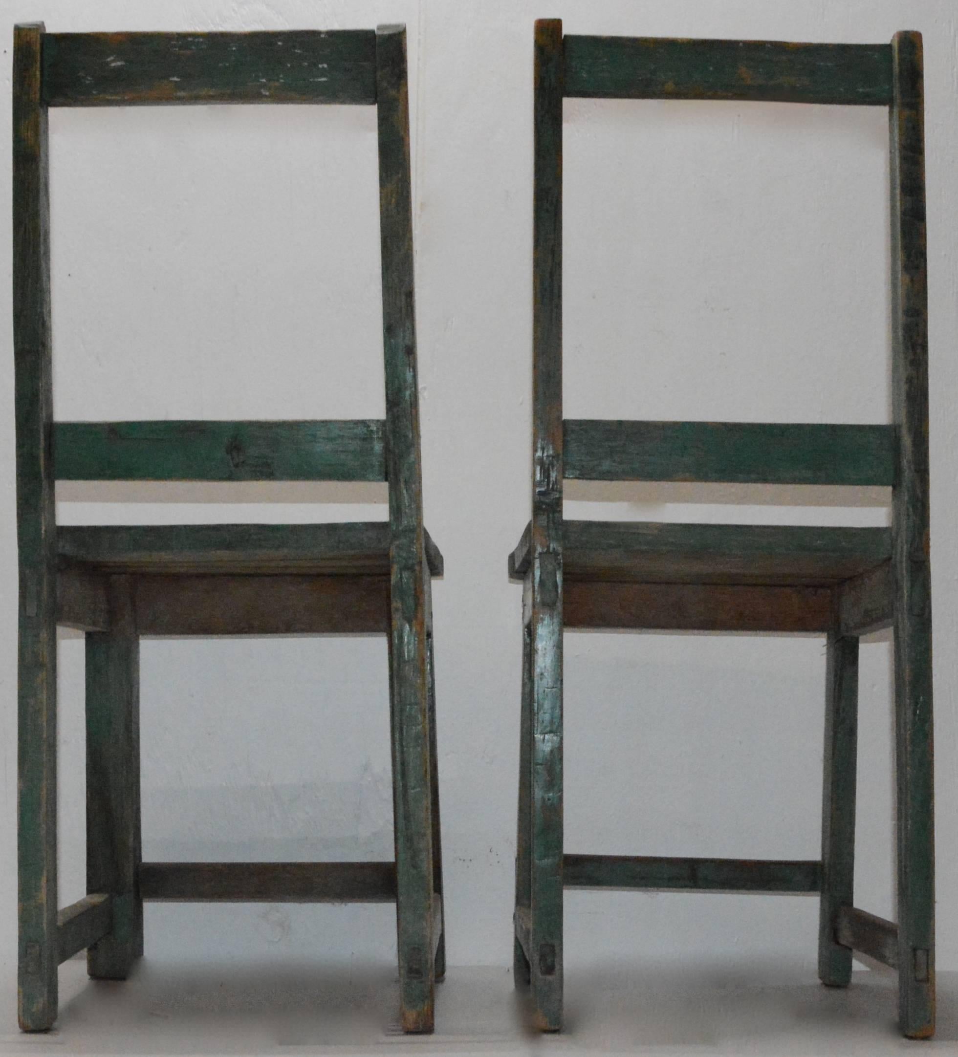 We are offering a unique style of Folk Art chairs in the Primitive style. The green paint has been worn down over the years to give the chairs a lovely patina. The wear on the chairs makes you wonder who has used them over the years!