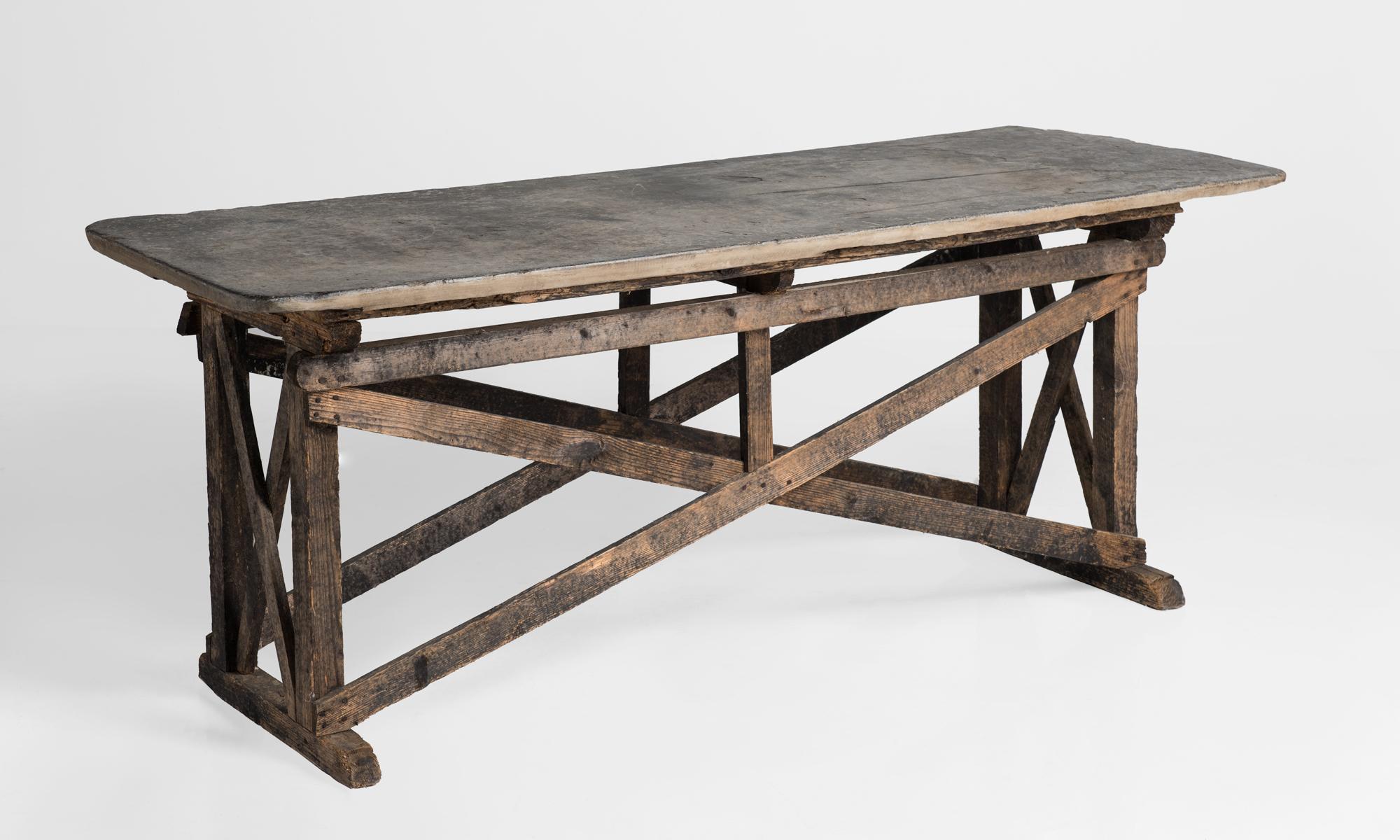 Primitive stone top console table, France, circa 1910.

Simple cross-beam form with slab top.

  