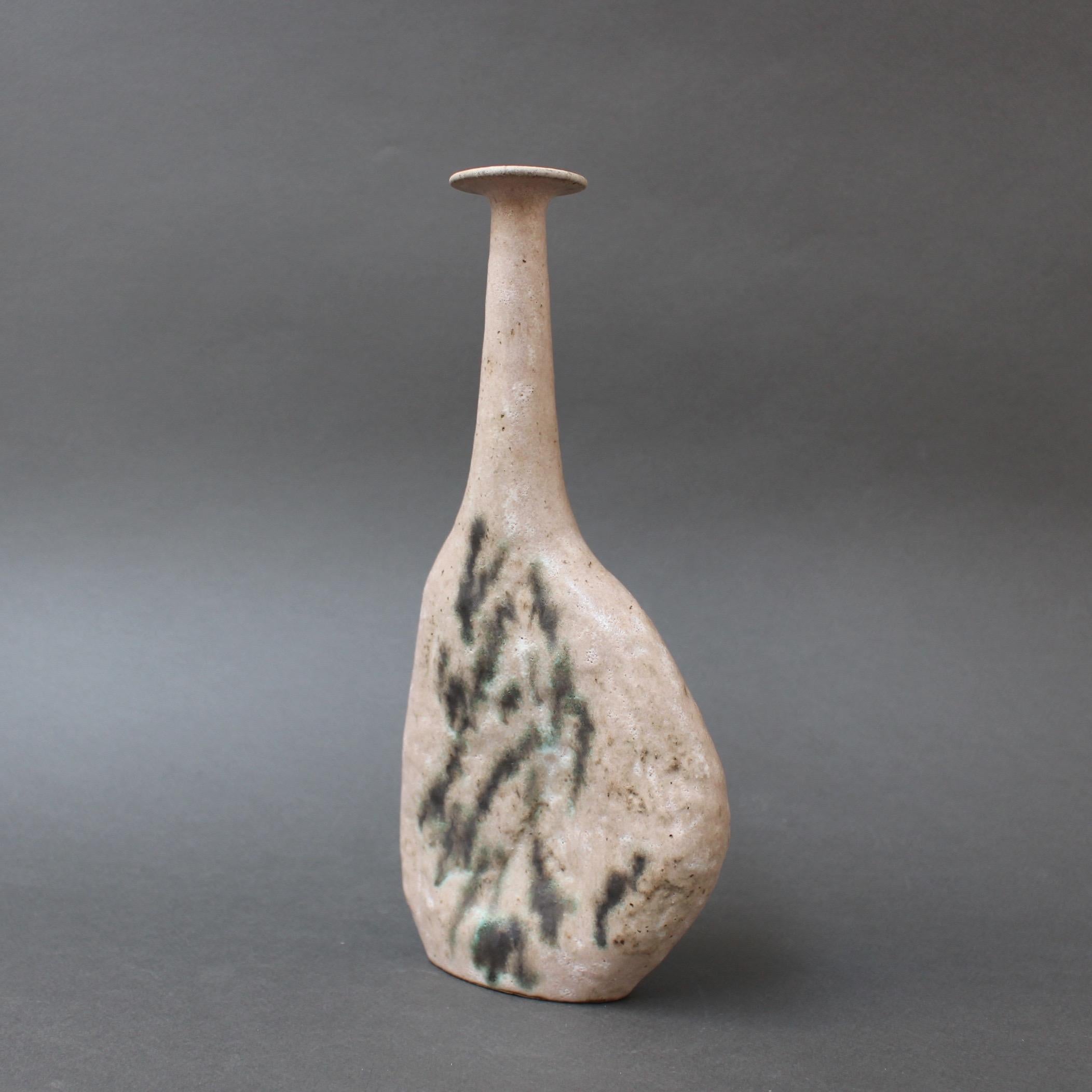 Stoneware Sassi model primitive style vase with dusty light rose glaze by ceramicist Bruno Gambone, circa 1980s. This graceful narrow-opening flower vase is a work of art. The elegant base is very tactile, its subtle colouring is marked with a