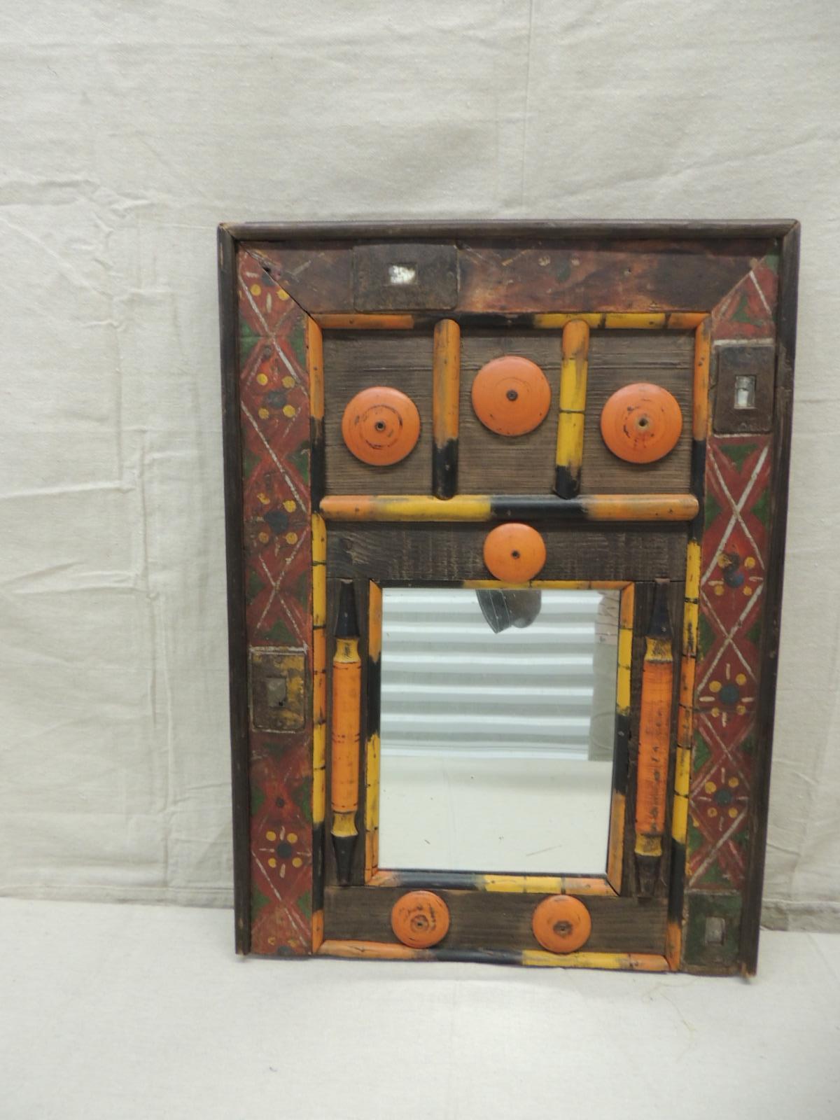 Colorful Folk Art wood mirror
Found objects and bamboo. Artisanal wall mirror
Mirror and glass insets. Floral trellis pattern.
Size: 16.5 x 22.75 H x 1.75 D
7.5 x 9 inside mirror.
 