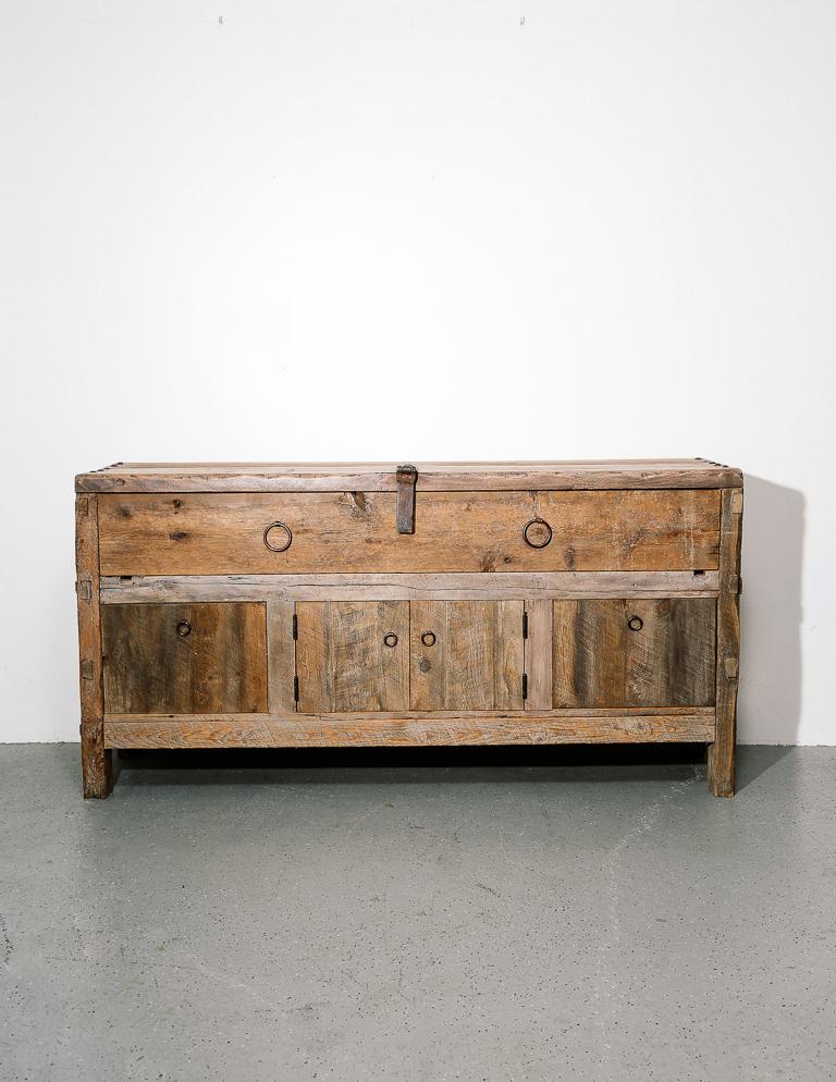 Primitive style credenza or sideboard built from reclaimed materials. Iron ring pulls and latch. One large drawer, 2 smaller drawers, and 2-door cabinet. There is a hole cut in the back for electronics.