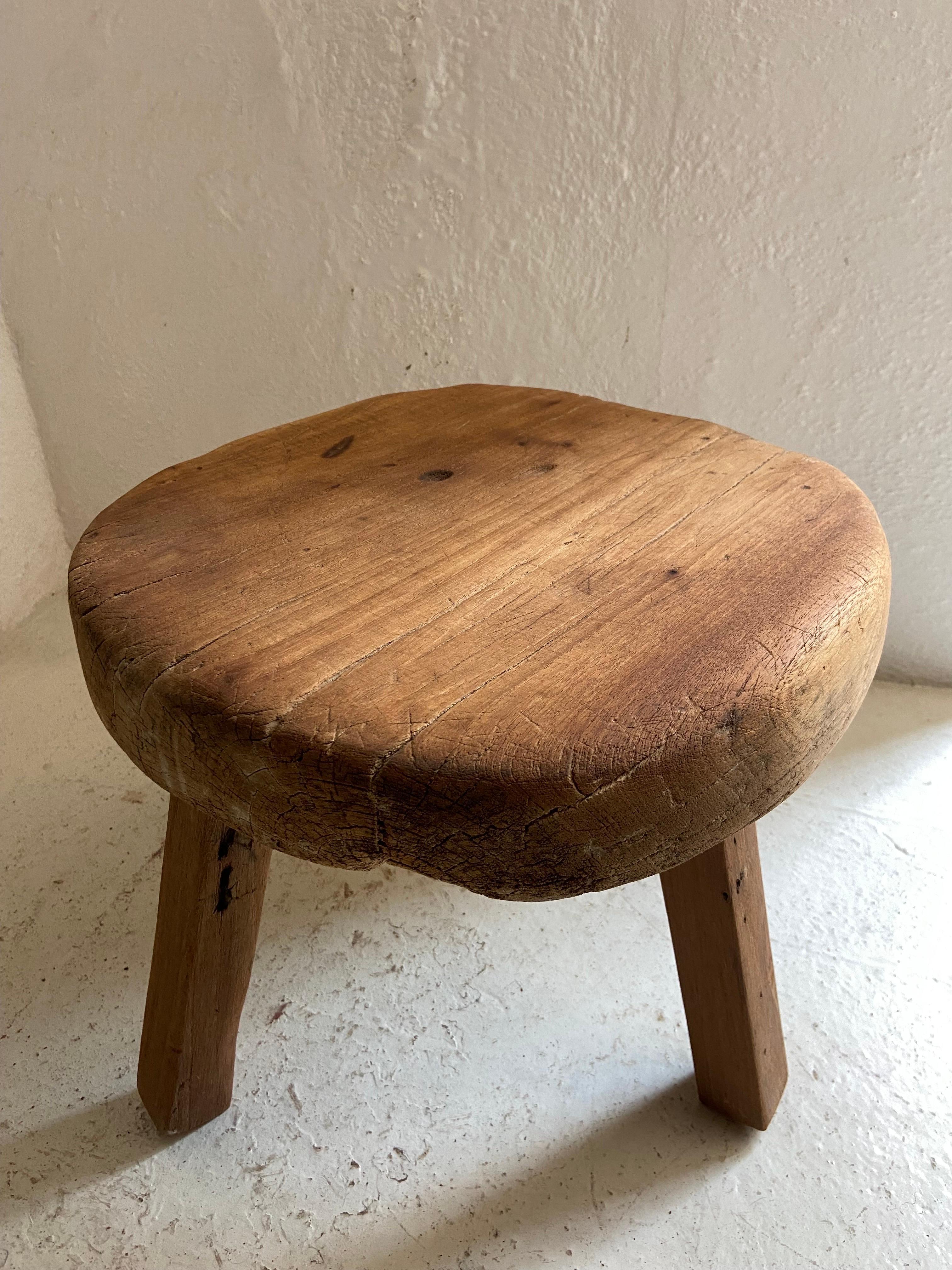 Primitive style round table from Yucatan, Mexico, circa 1980's. The legs are not original. They are fabricated out of reclaimed beams. The table top is irregular with strong character.
