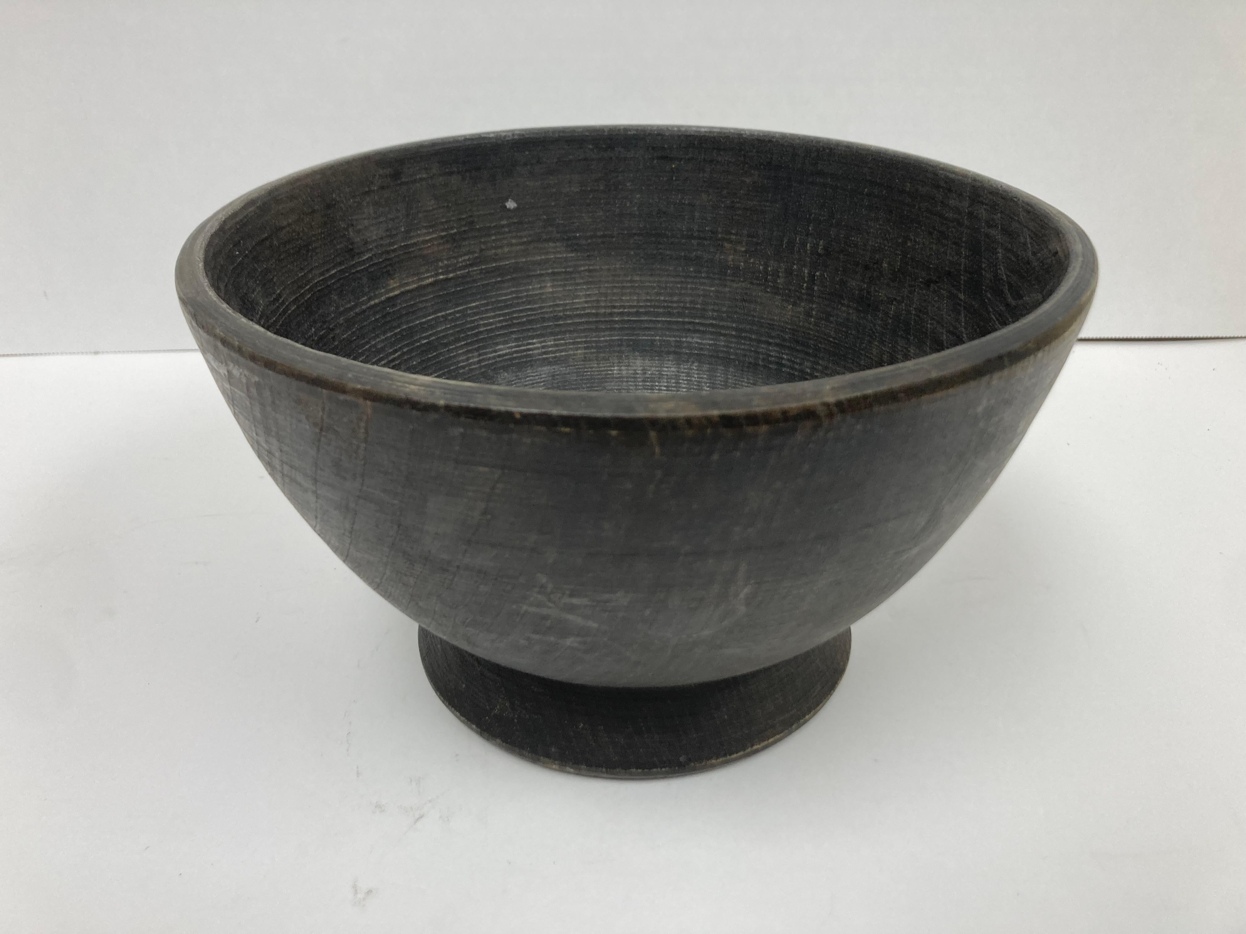 A very well made and solid Turned Wood Bowl with elemental form and footed base. The turning marks are evident and add interest and the Bowl may be used for any number of decorative purposes. 

Dimensions: 8.75” by 5” high. 

Condition: Please see