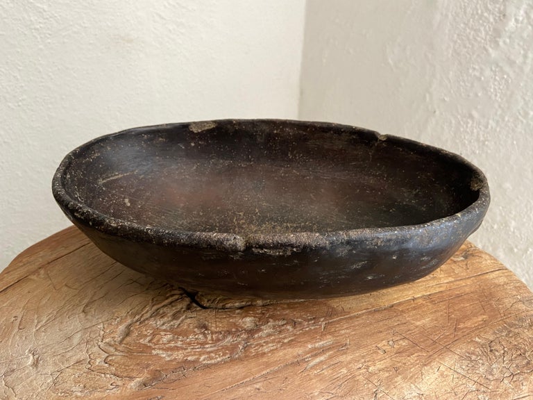 Primitive styled, black clay ceramic bowl from Oaxaca's Mixteca region, circa 1940s. Used for rinsing ones hands after mixing the corn maza for making tortillas. The texture and patina on the vessel is unusual.