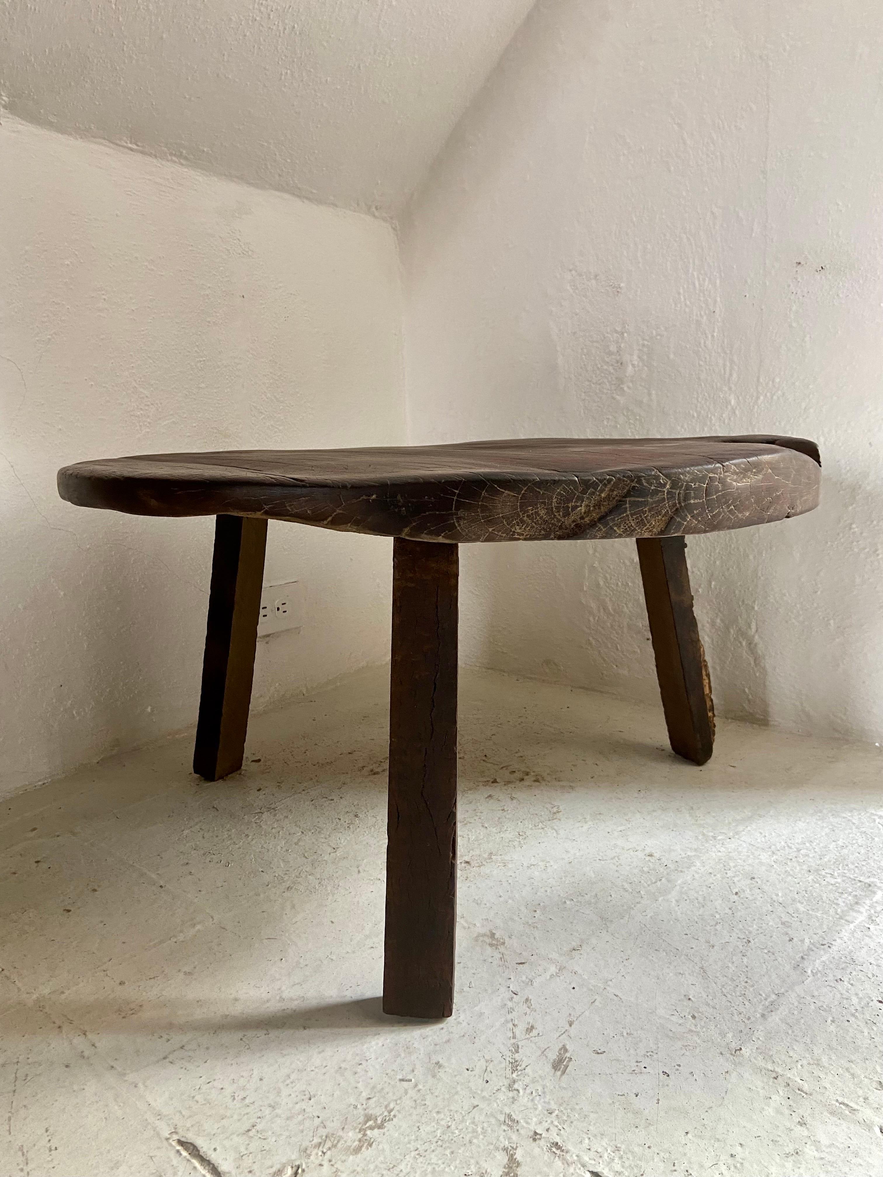 Primitive styled low roundtable from Yucatan, Mexico, circa 1960's. Strong character, deep color and patina. The table is of an unusual size. Tree trunks at these sizes are no longer available in the rainforest. These low tables are really only used