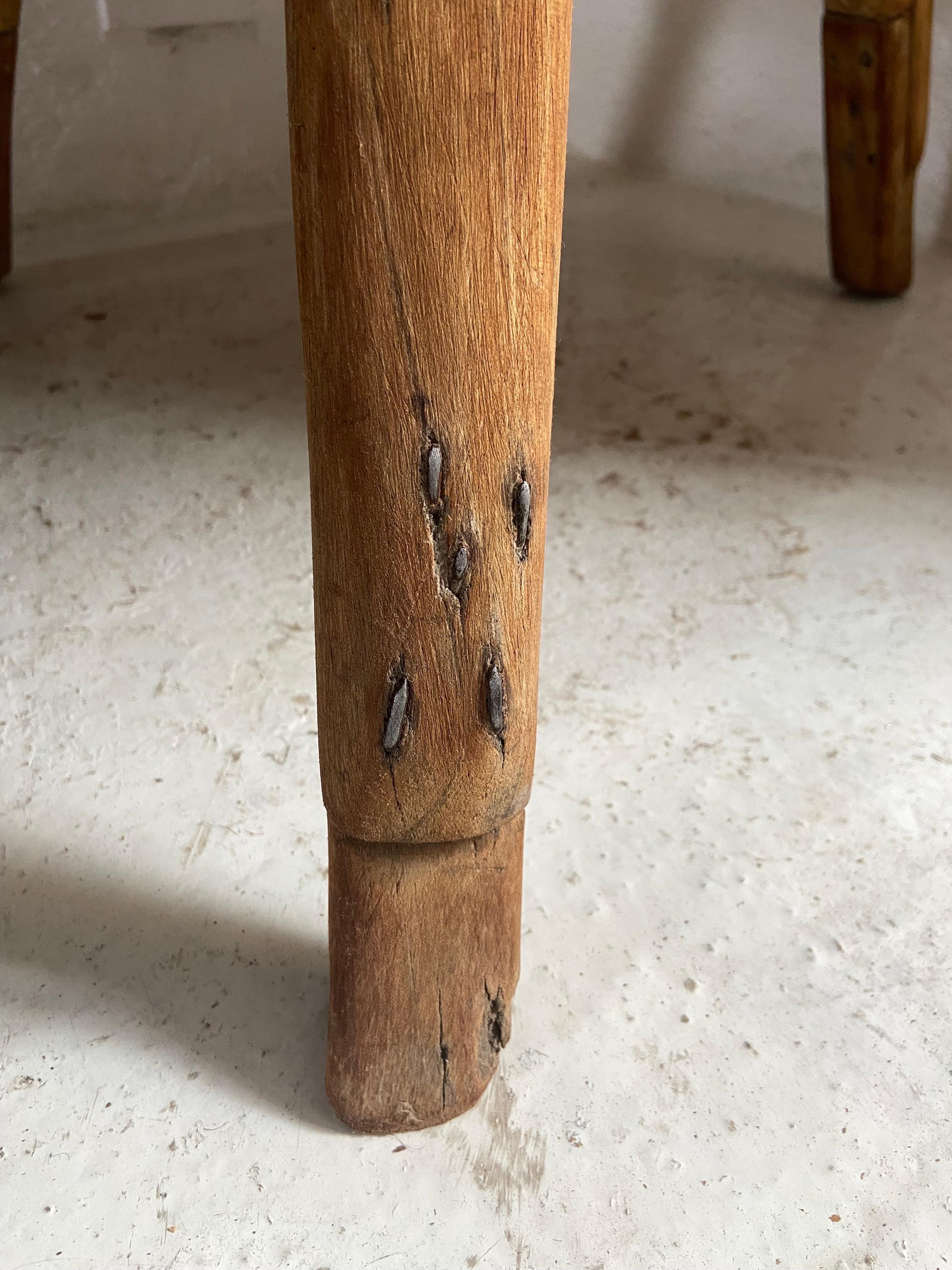 Primitive low table from Yucatan, Mexico, circa 1970´s.  Unusual cut out at bottom of table top. Original retrofit on legs from carver for increased height. Hand carved tables such as these were once common in the 1970´s and earlier but have since