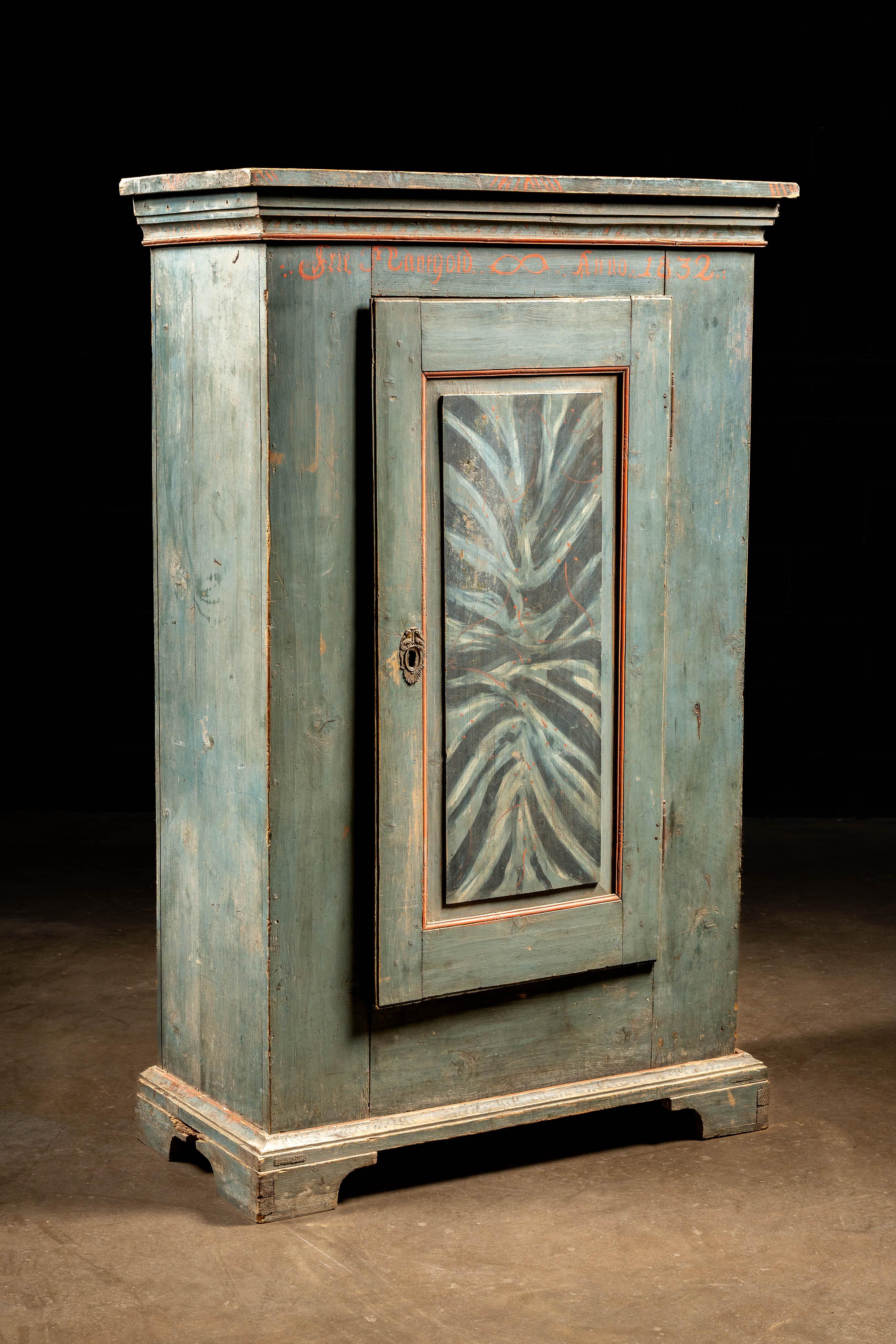 (Likely) 19th century Swedish or other Scandinavian rustic painted pine cabinet.

This piece features a thin coat of pale blue paint throughout with painted script along across the top below the molding, possibly dating this to the mid-19th century.