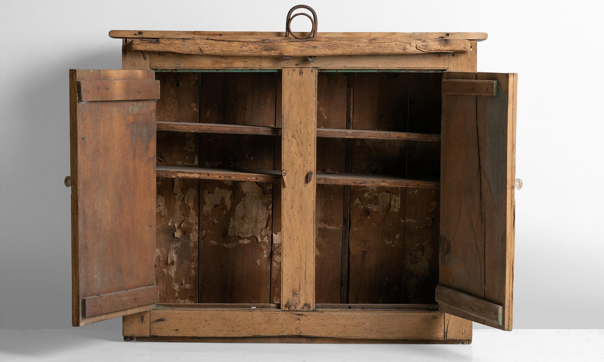 Oak construction, with decorative wrought iron detail and humble frosted glass drawer pulls. Originally from a barn in Richmond, Rhode Island.