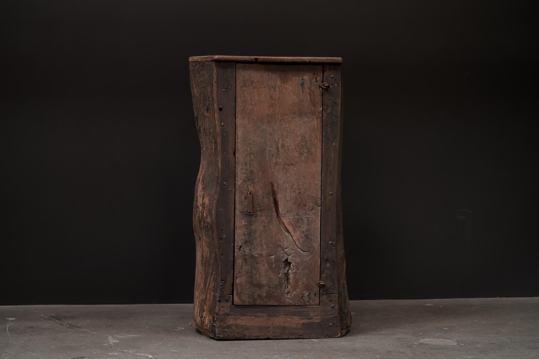 Primitive Tree Trunk Cabinet, Belgium
Circa 1930's 
Wood with floral paper design on inside door. 