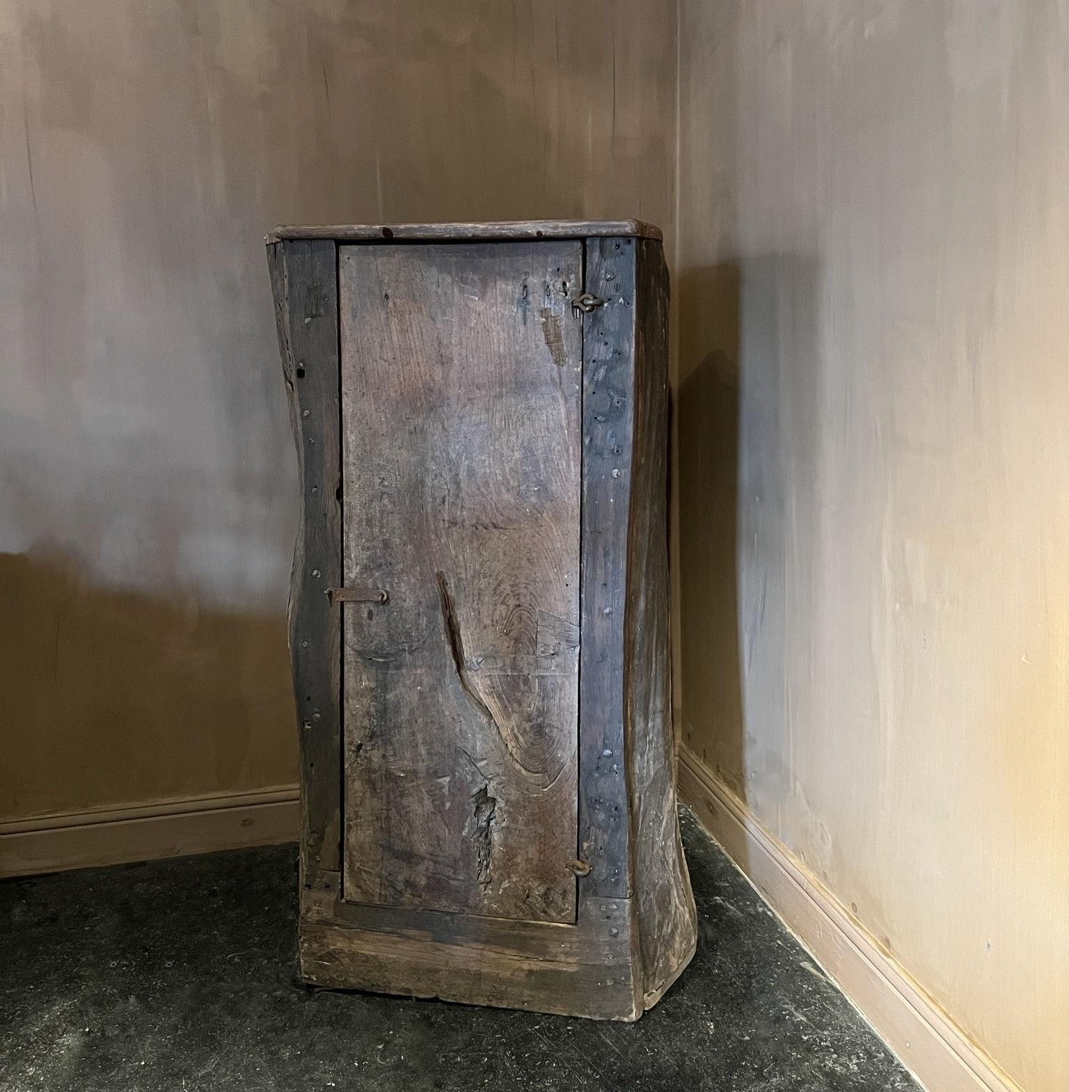 A so called 'Armoire Berle' from the French Ardeche region. Carved out one solid chestnut tree by local artisans in the 19th century. Great color and patina running troughout with a beautifully faded naive flowerpainting on the inside of the door.