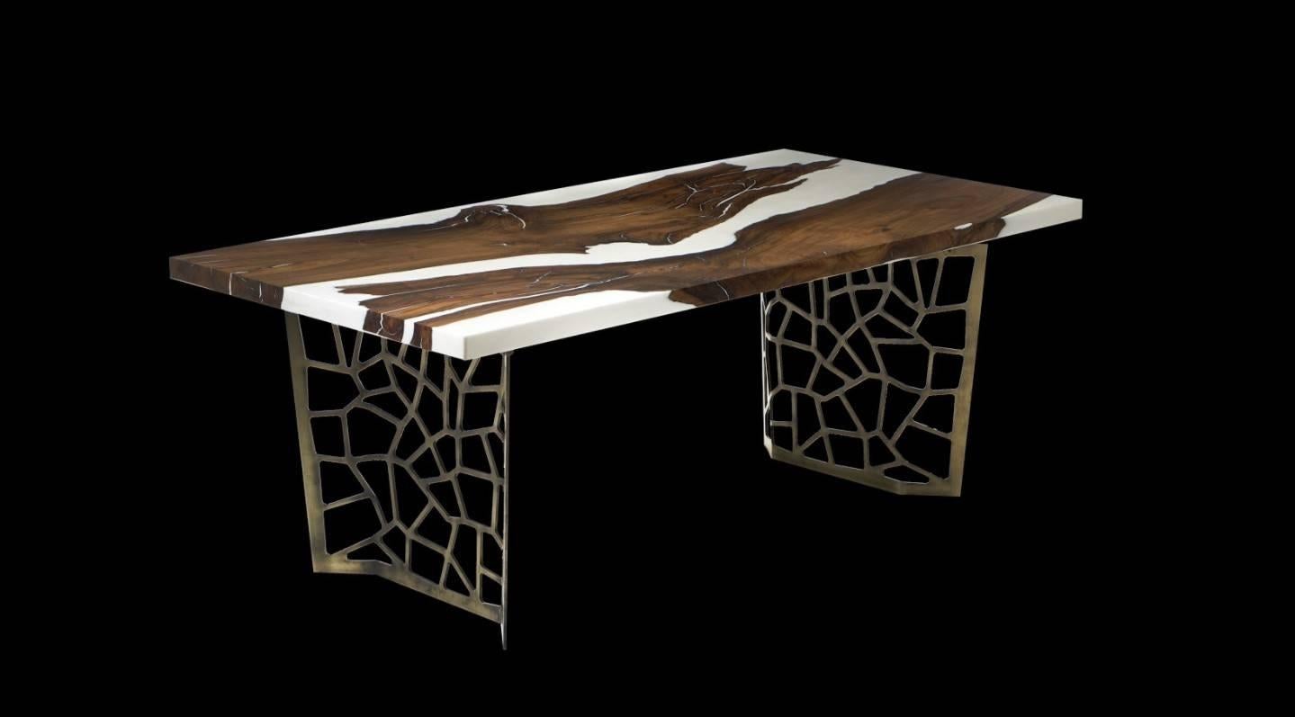 Our mineral white epoxy is nothing short of pure perfection. The white resin amplifies the caramel rich tones of the black walnut wood. On a base of rustic cast iron with CNC cut geometric patterns, this table will spark conversation and emotion
