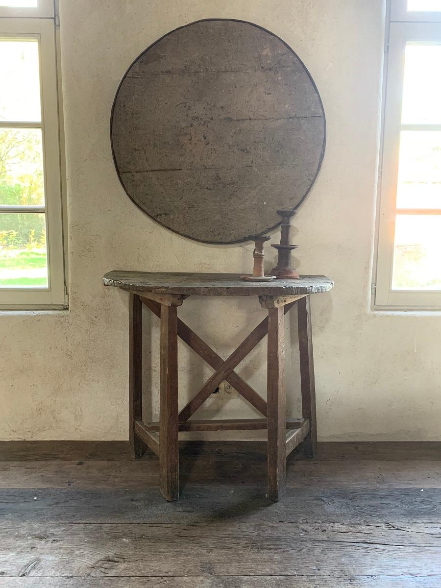 A 19th century winetable top mounted as a circular painting. These tables were used by French and Italian farmers to have a meal on the field or a glass in the winecellar. With their folding top they were light and easy to carry around. This example