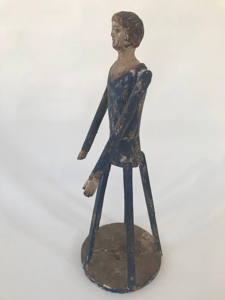 Articulated arms and old paint on this unusual cage doll. In the manner of a Santos, this Folk Art woman seems less a religious figure than a wonderful piece of Folk Art. Wear and losses do not detract from this special piece.