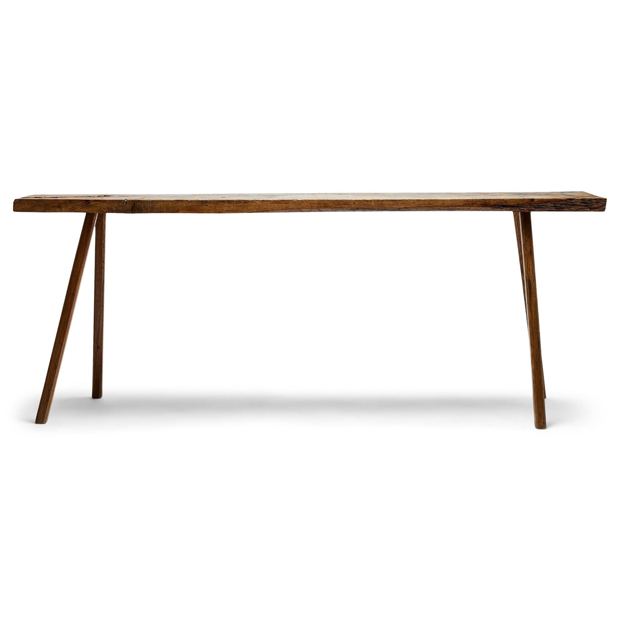 A primitive oak console table with tenon legs.