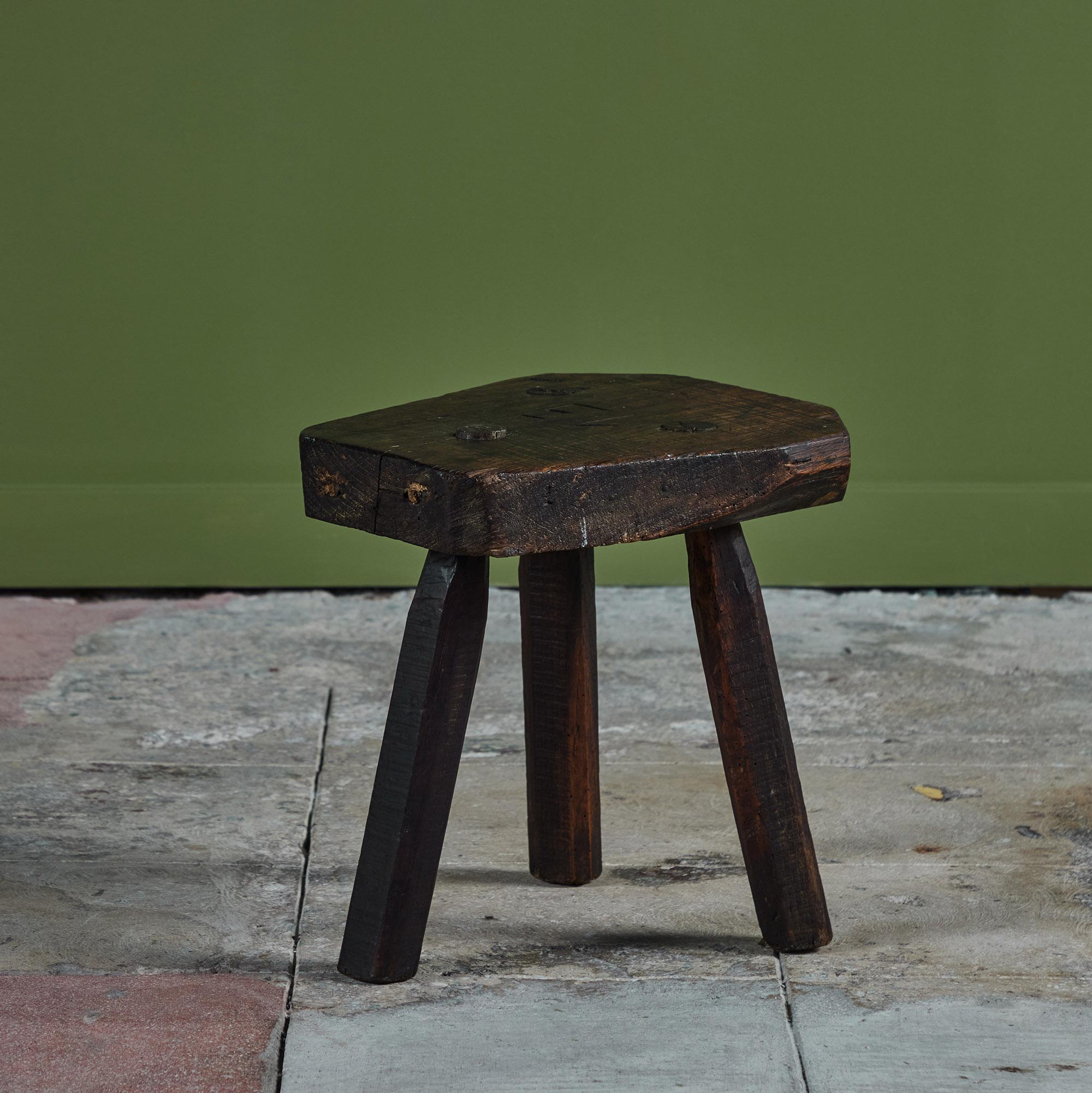Wood tripod milking stool from the late 18th Century. The stool features a thick seat that sits atop three spayed legs. A beautiful stool or side table.
Signed on seat top.

Dimensions
13