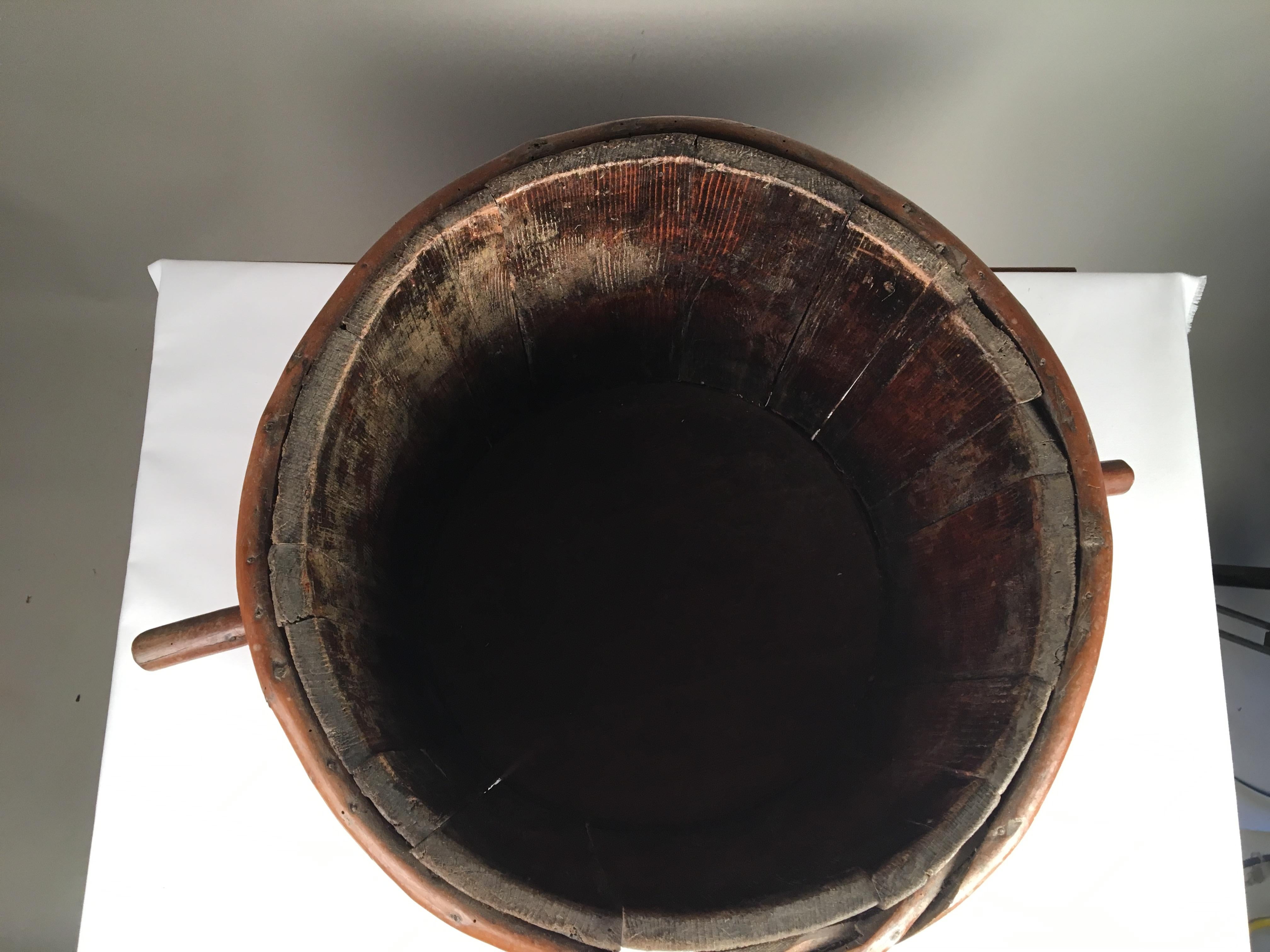 An 18th century French handmade wooden water bucket with two handles.