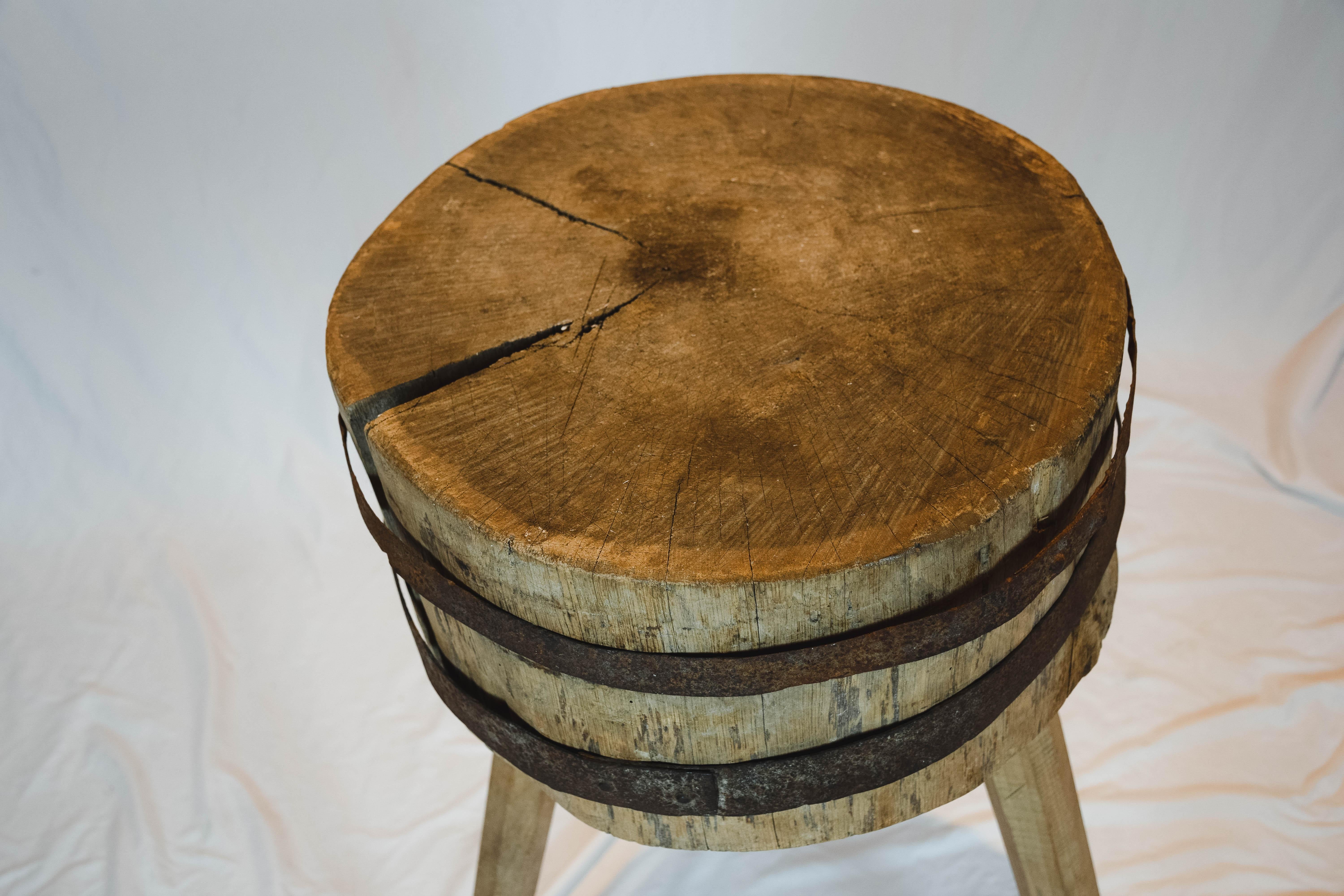 This Simple Wooden block table is from France. Appears to be carved out of single slab of wood with iron strappings. It has a beautiful weathered finish. Great to use as an accent table. France, circa 1850. Weathered, small losses. The three legs