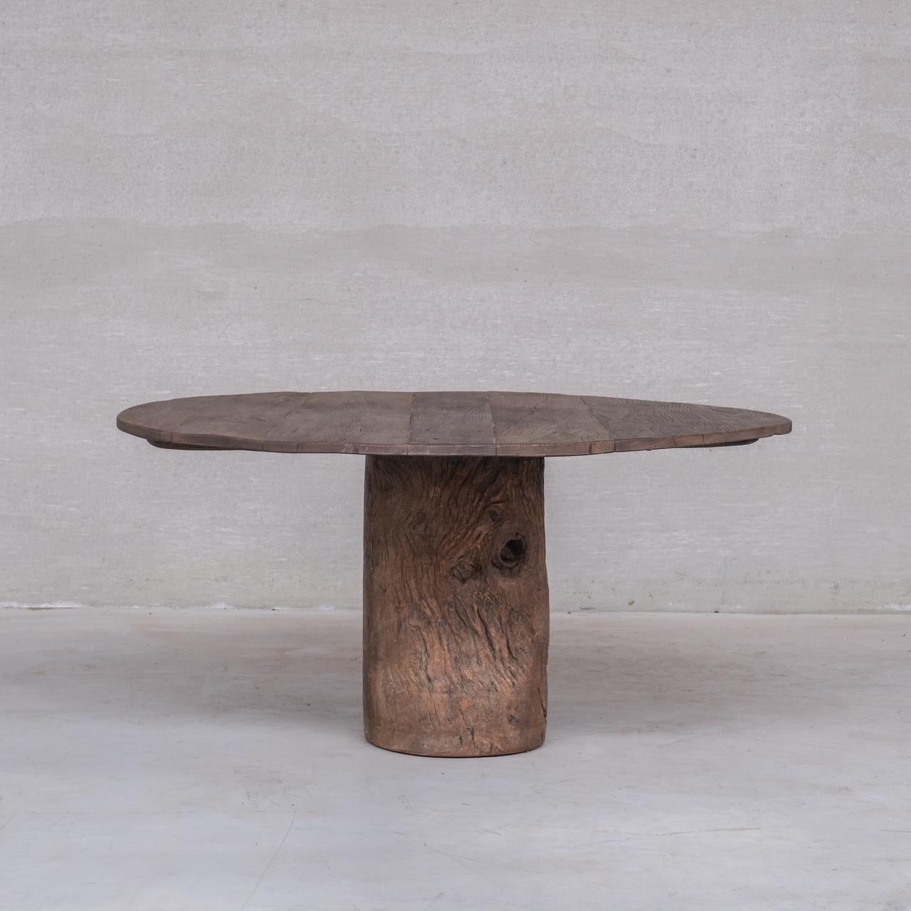 A primitive wabi-sabi style circular dining table or centre table.

Belgium, c1930s.

A marriage of old wood created recently by artisans in Belgium.

Contemporary wooden sub structure allows the top to be removed.

The base and top is from vintage