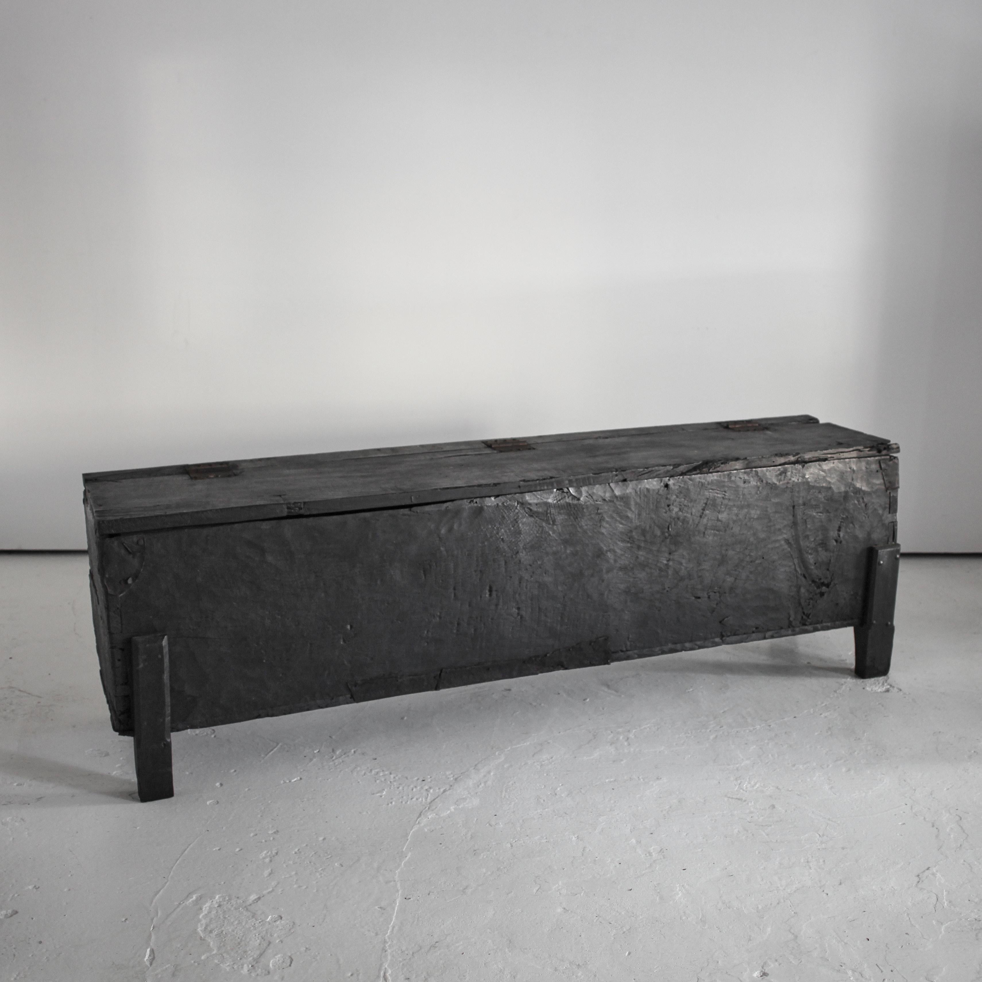 An XXL northern Portuguese hewn charred chestnut coffer from the early 19th C.

Beautiful patination with age old metal repairs.

Perfect as a console and/or storage.