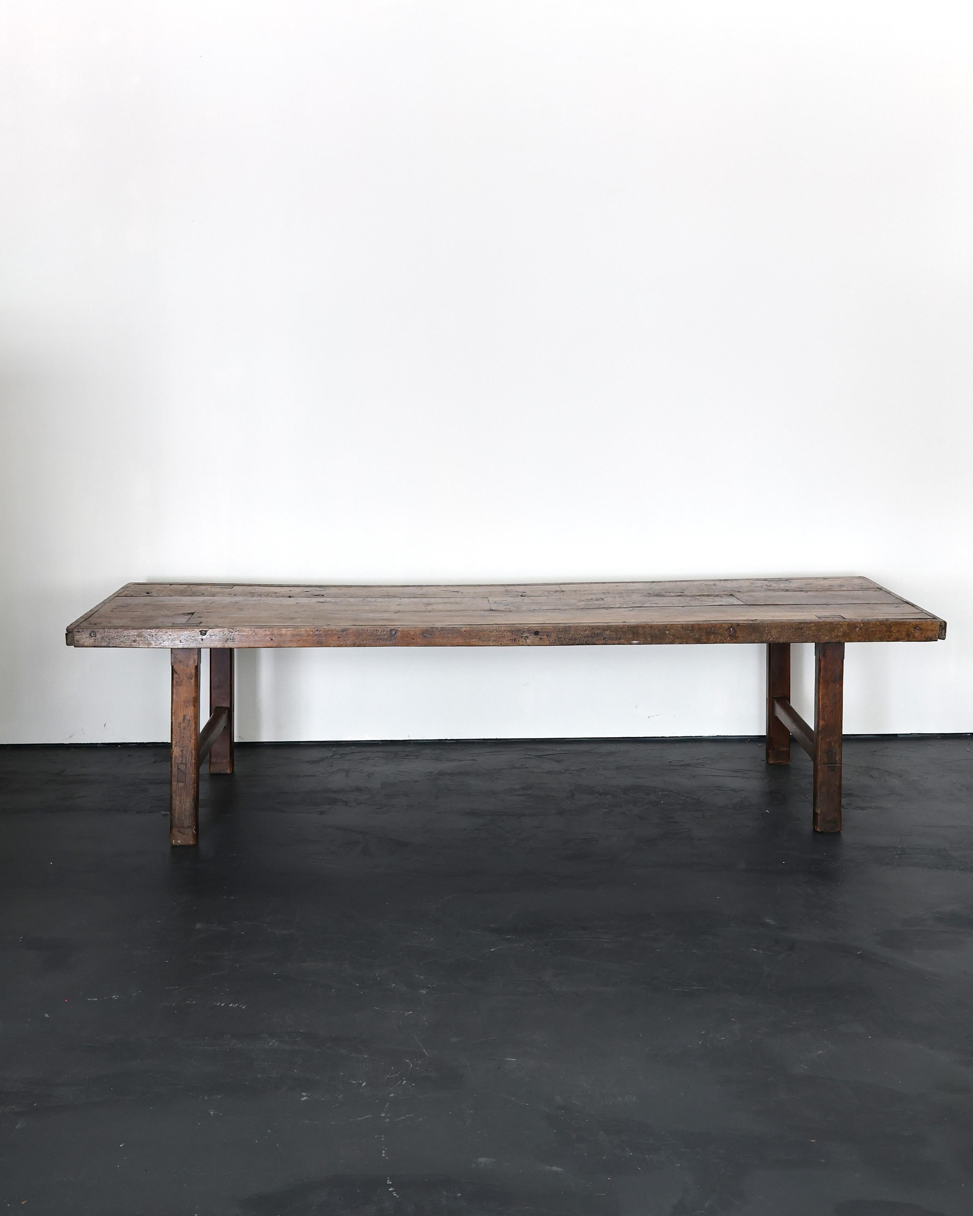 An XXL early 19th C. dinning table from the department of Calvados in lower Normandy.

Constructed in thick slabs of elm with a strong utilitarian design.

Originally used as a prep table in a chateaux/country estate.

Heavily patinated with many
